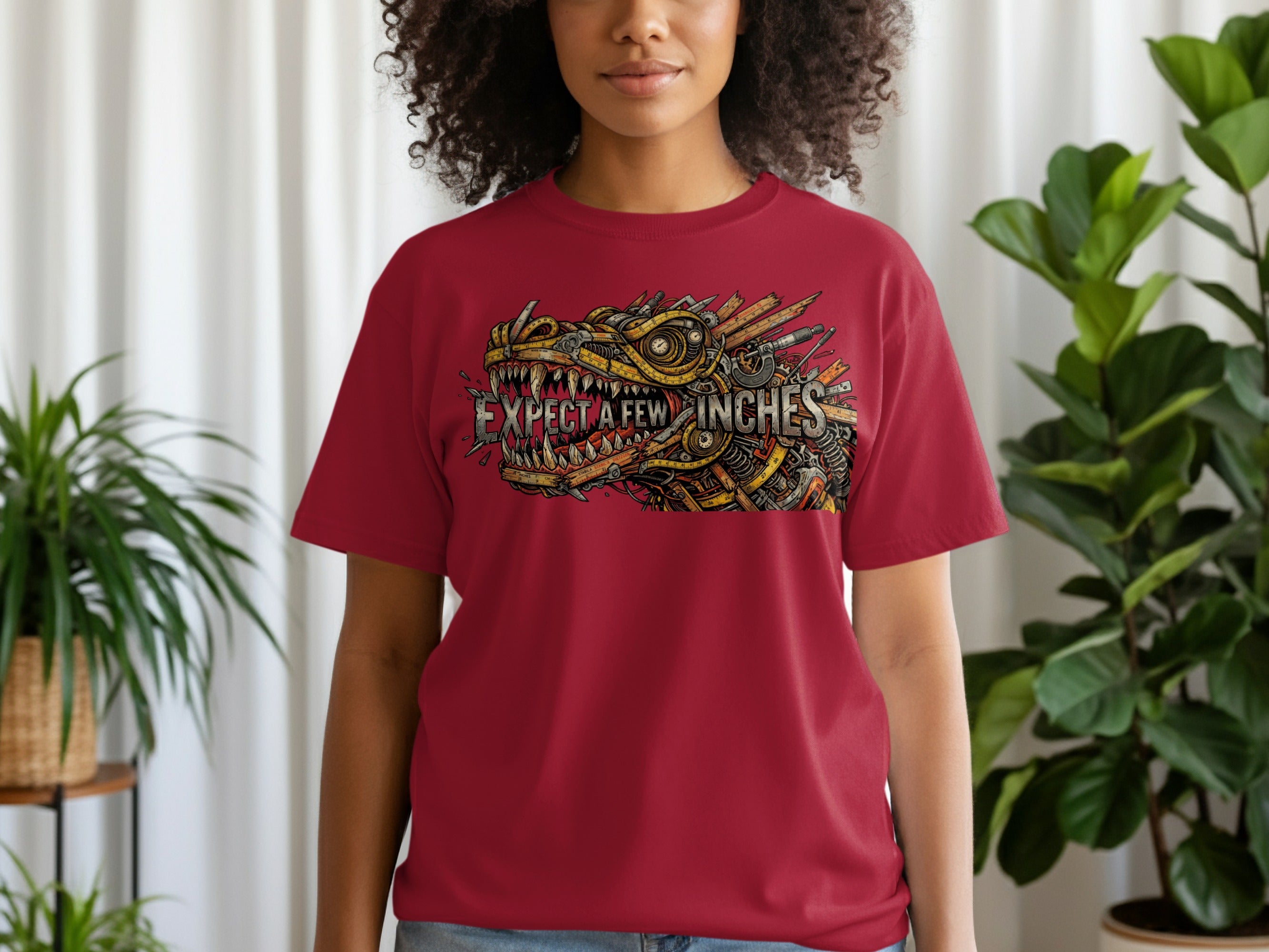 T-shirt graphic of a dragon head made of tools with text "EXPECT A FEW INCHES".
