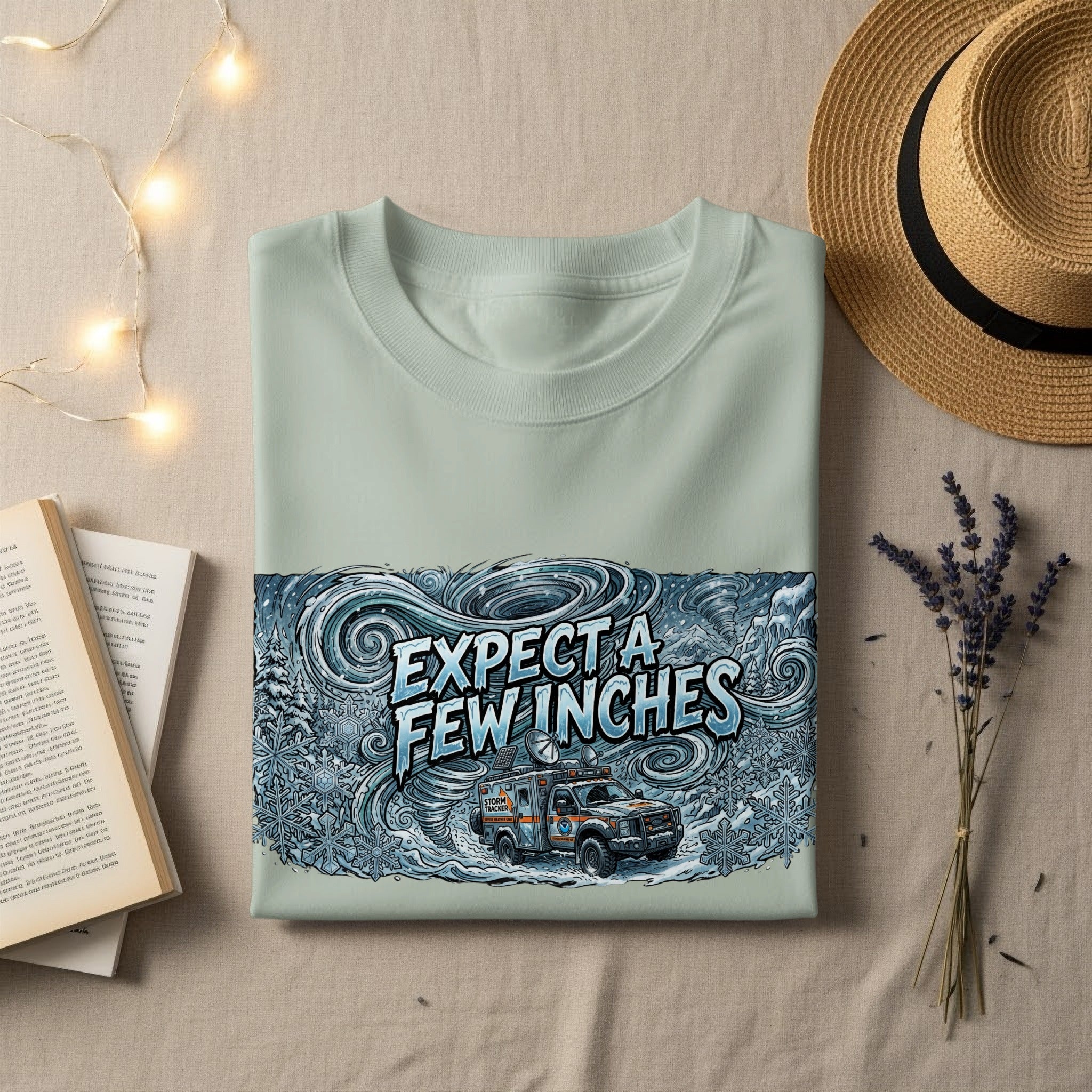 Pale blue t-shirt with "Expect a few inches" and storm truck graphic.