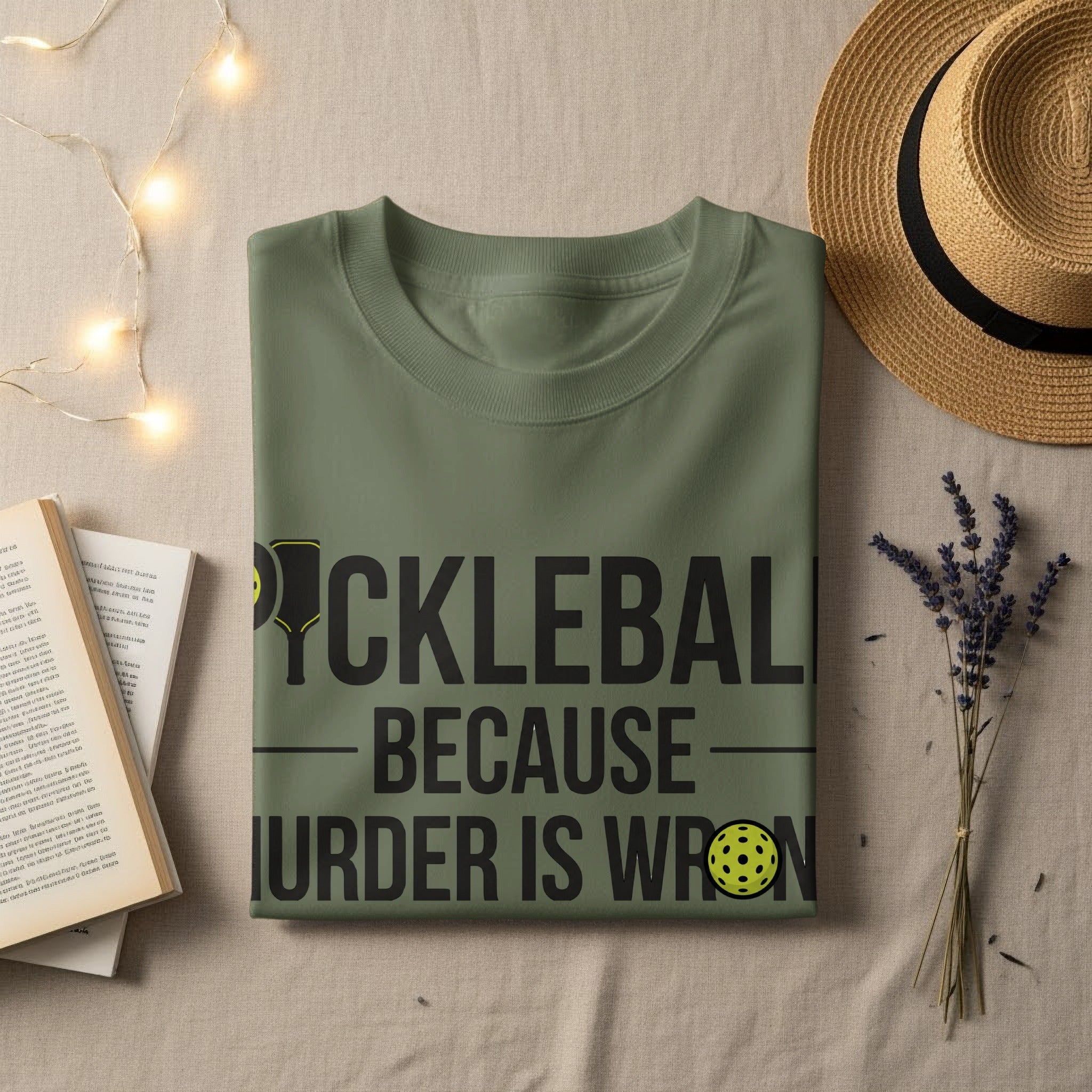 Olive green t-shirt with "Pickleball Because Murder Is Wrong" graphic and pickleball.