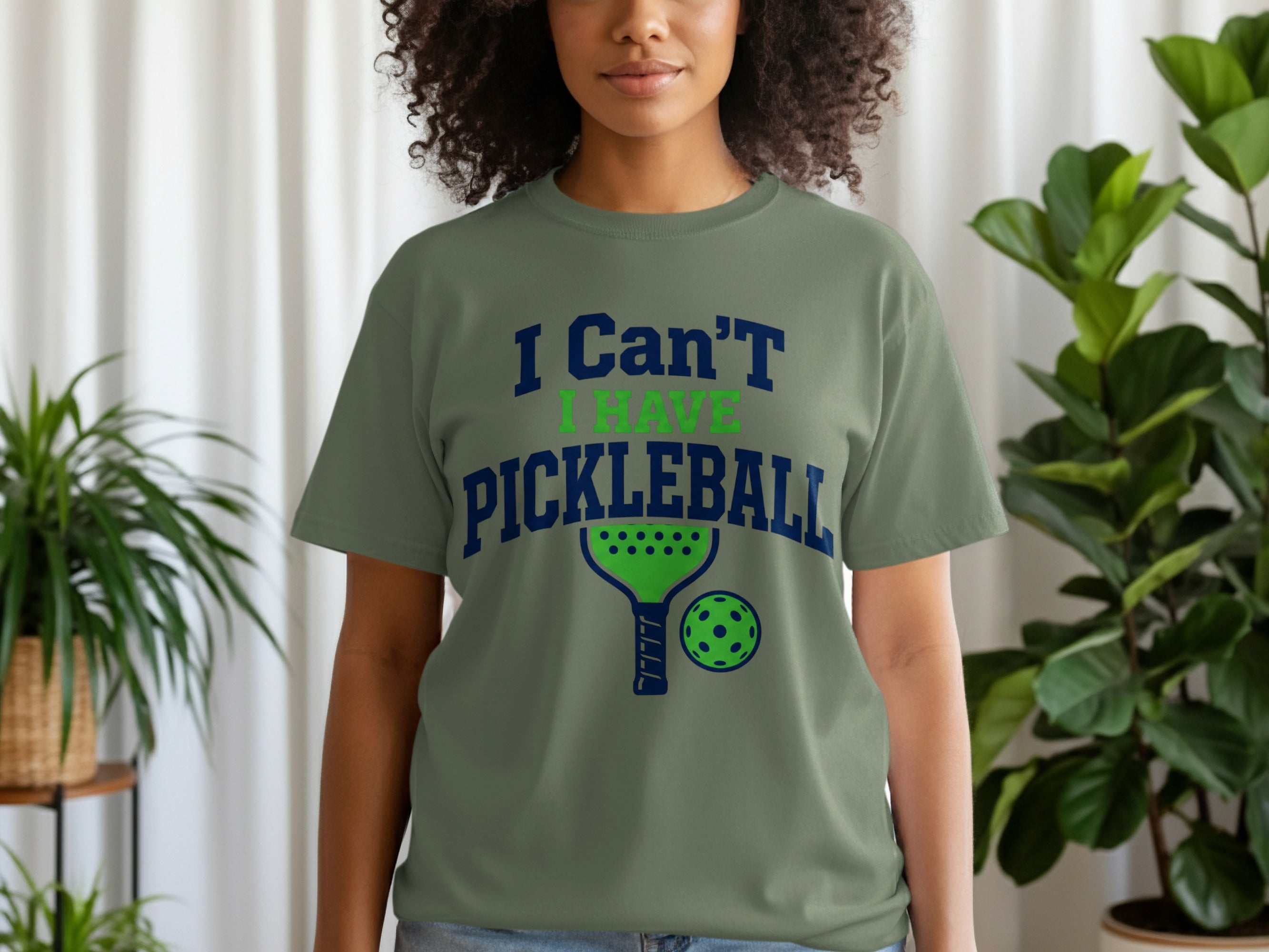 Green t-shirt with "I Can't Have Pickleball" graphic and pickleball paddle and ball.