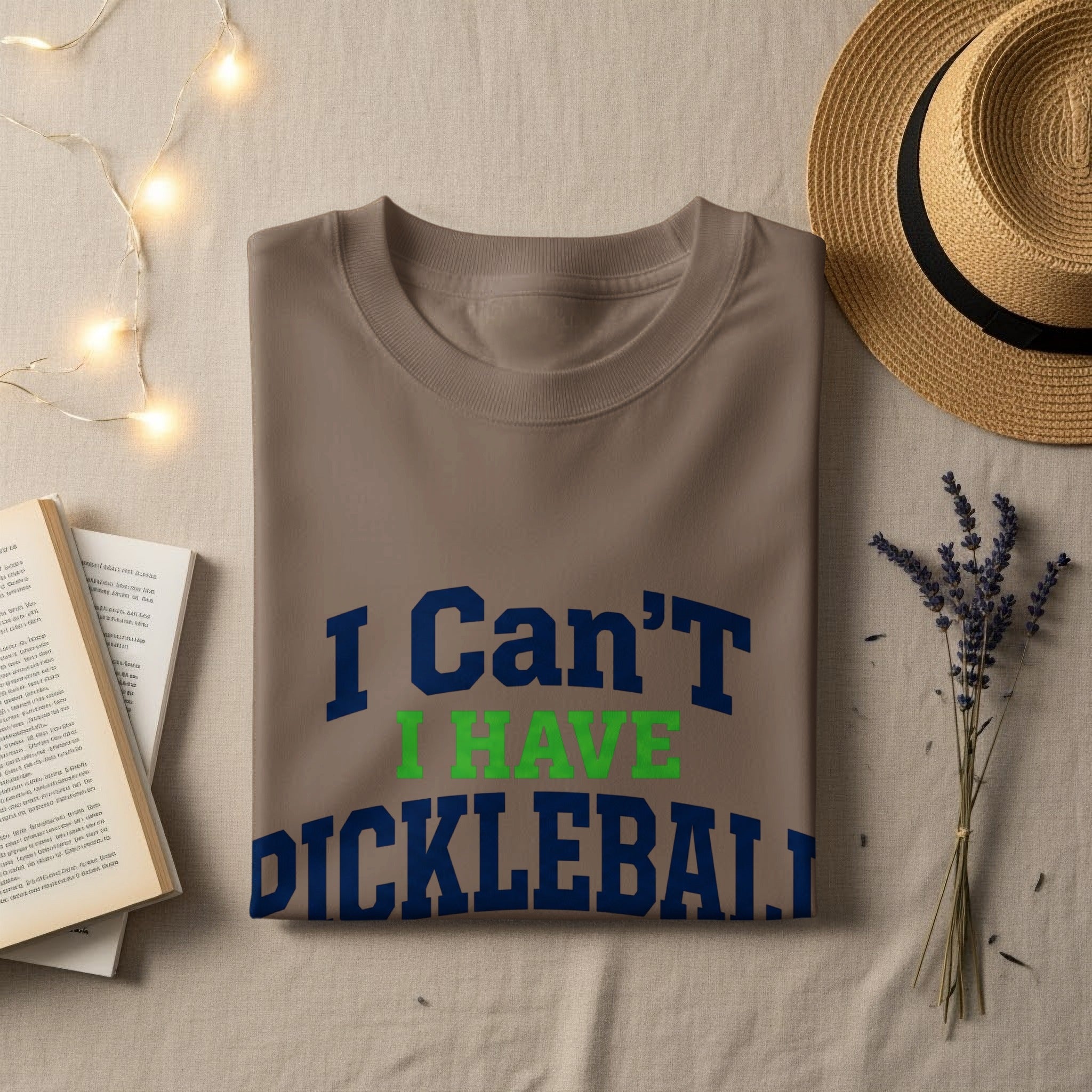 Brown t-shirt with "I Can't Have Pickleball" text in blue and green.