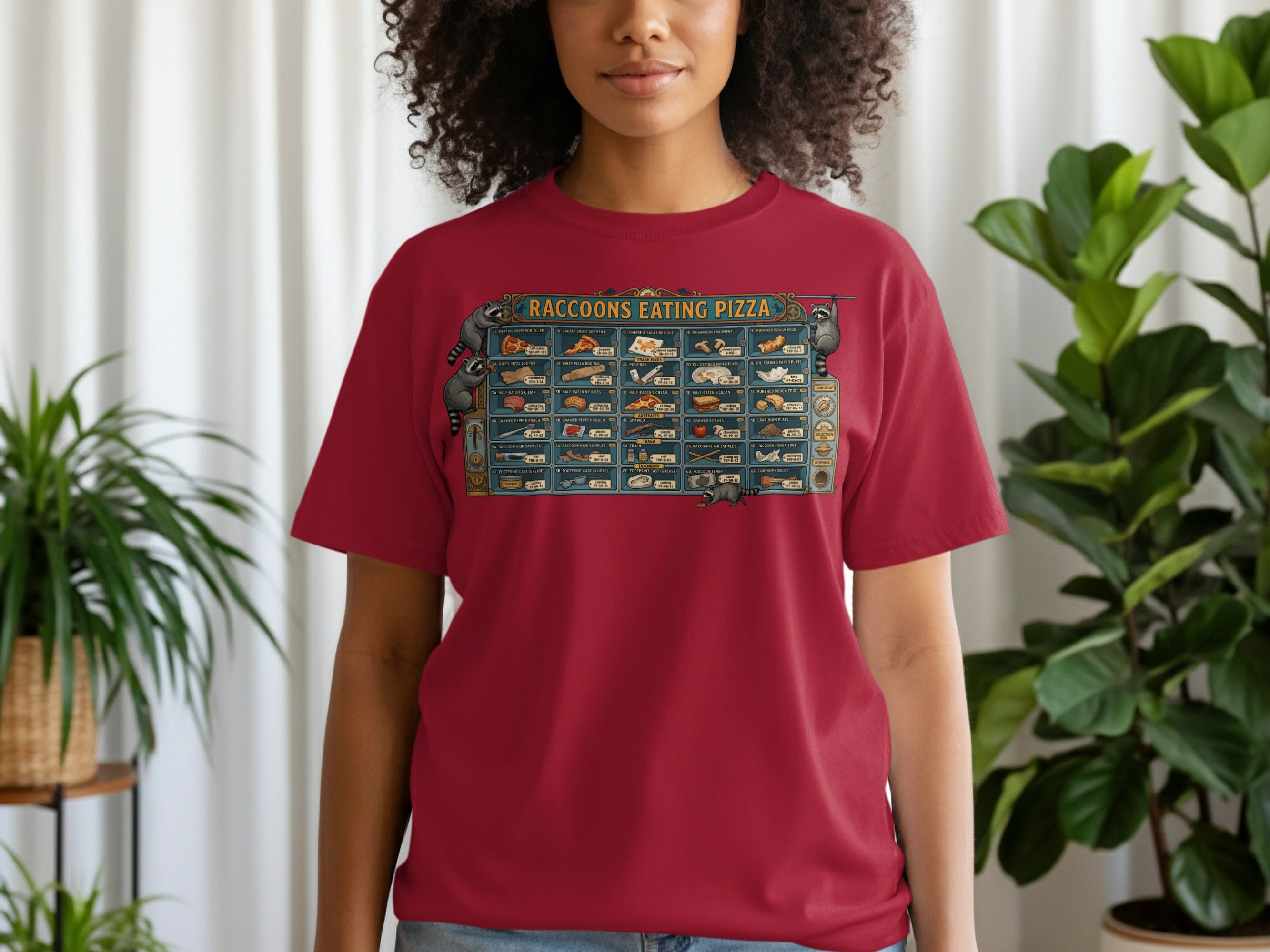 Red t-shirt with "Raccoons Eating Pizza" menu graphic and raccoon illustrations.