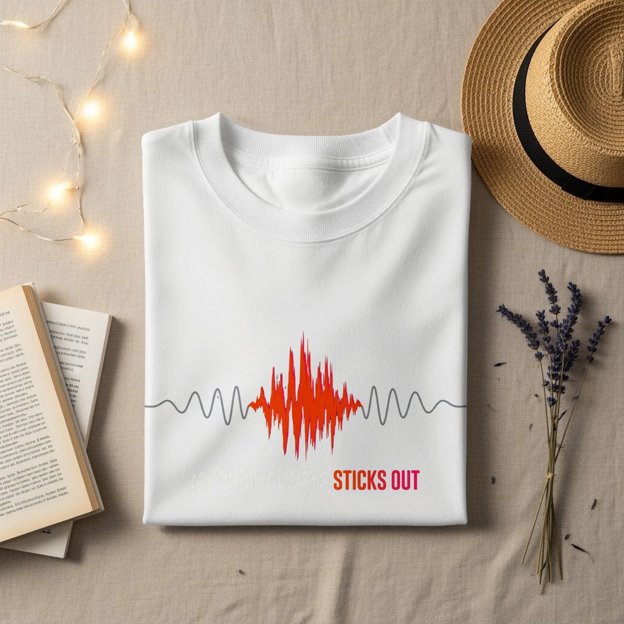 White t-shirt with red and orange sound wave graphic and "MY VOICE ALWAYS STICKS OUT" text.