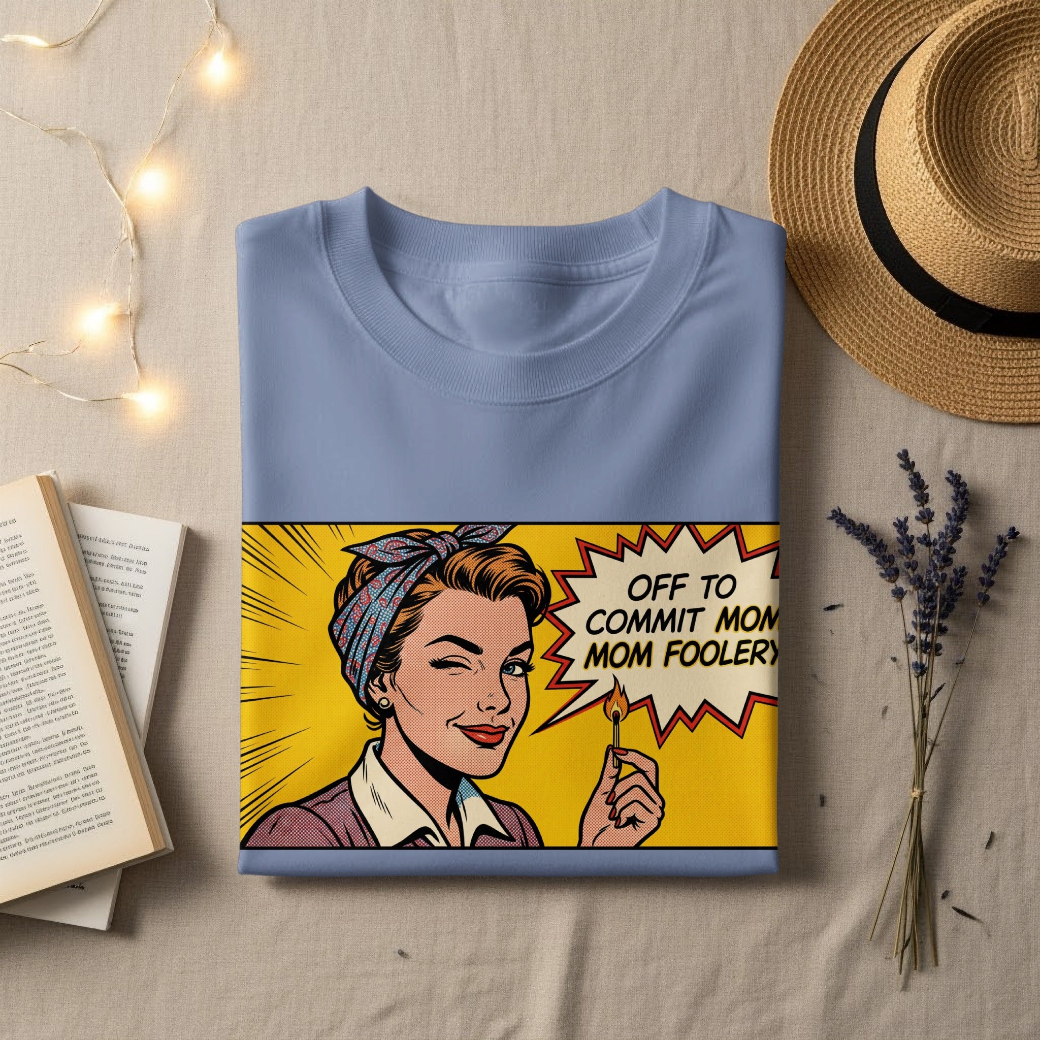T-shirt with comic book style illustration of a woman holding a lit match, saying "Off to commit mom foolery".