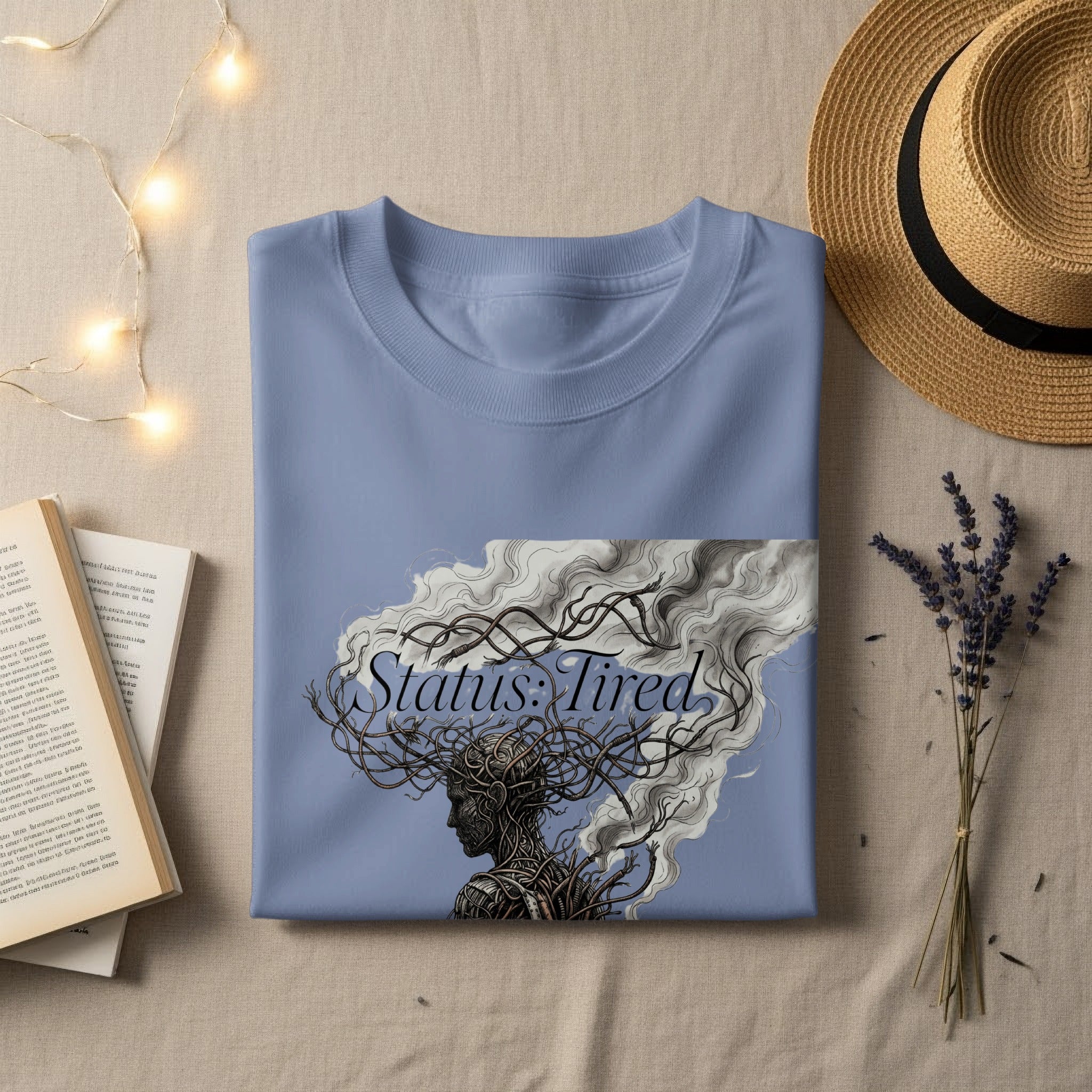 Blue t-shirt with "Status: Tired" graphic of a woman with tangled hair.