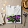 White t-shirt with "YOU ARE UNFROGGETABLE" graffiti art featuring a frog wearing sunglasses.