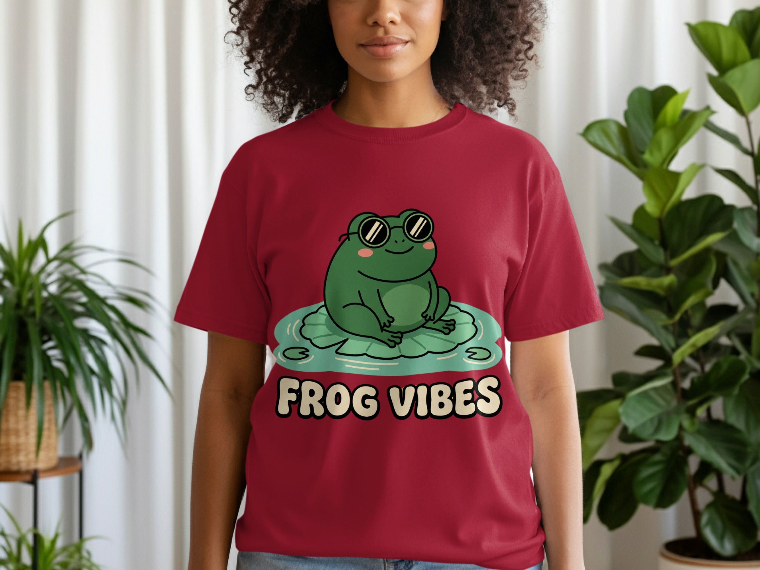 Maroon t-shirt with smiling frog in sunglasses on lily pad, text "FROG VIBES".