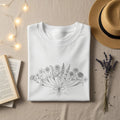 White t-shirt with a minimalist line drawing of a floral bouquet.