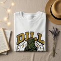 White t-shirt with "DILL" logo featuring a grumpy pickle character.