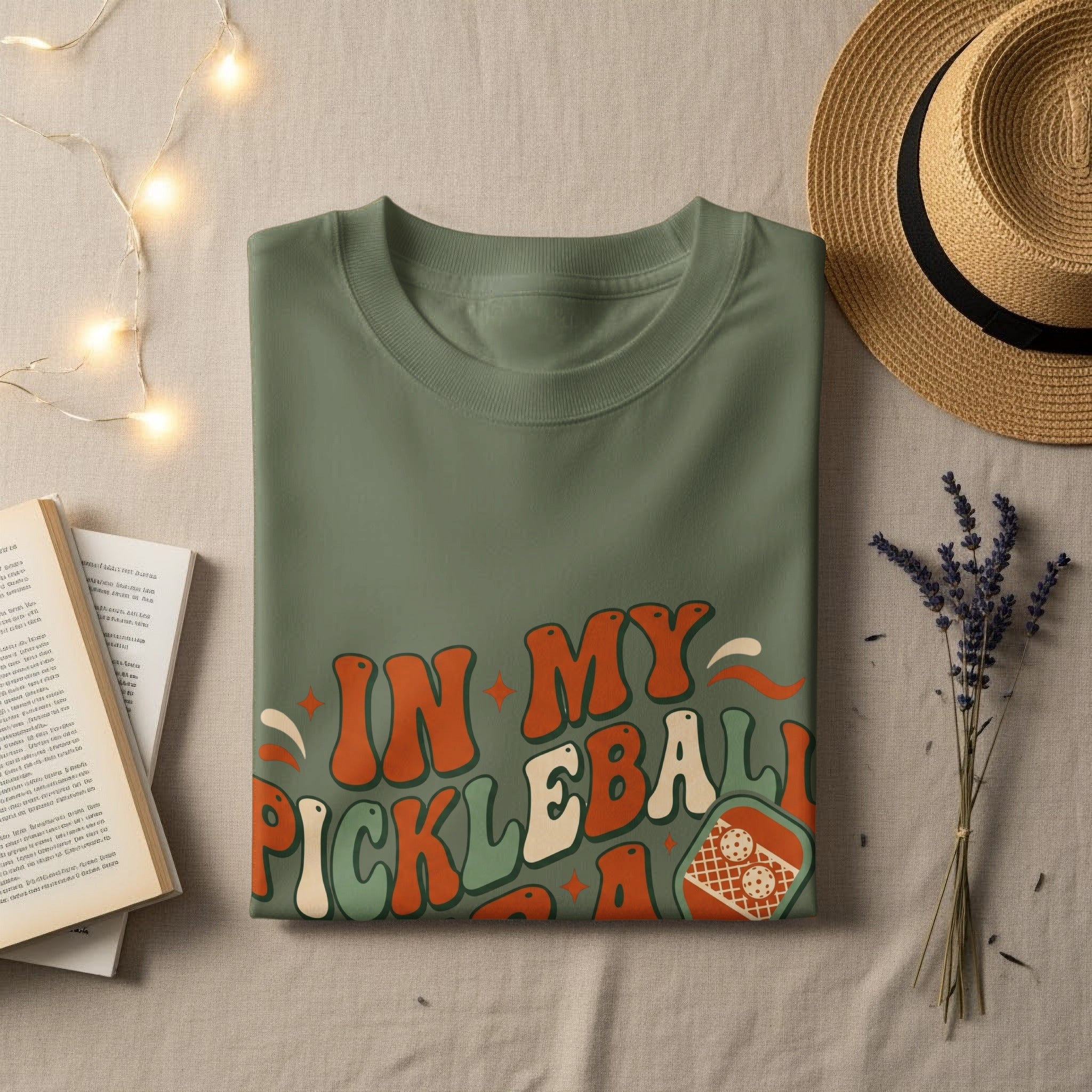 Olive green t-shirt with "In My Pickleball Era" graphic and pickleball paddle.