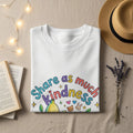 White t-shirt with "Share as much kindness" text and playful graphics.