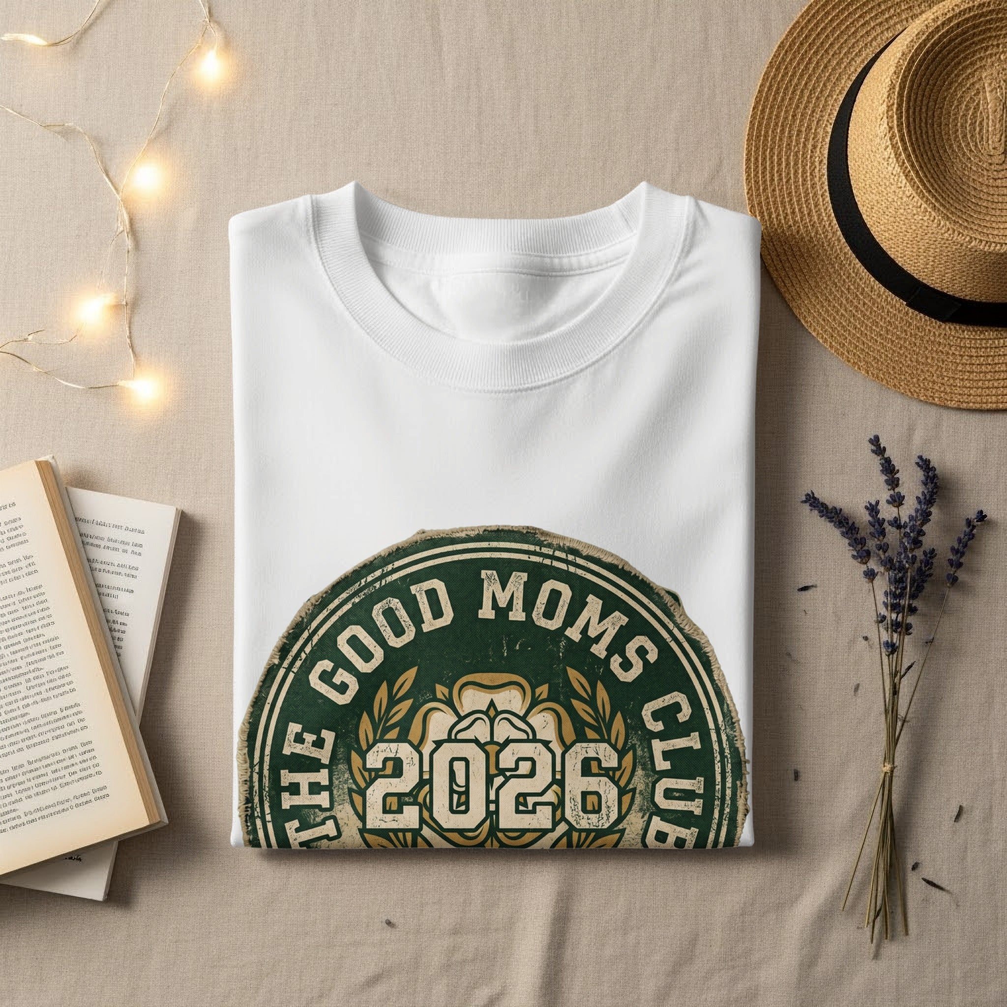 White sweatshirt with "The Good Moms Club 2026" logo.