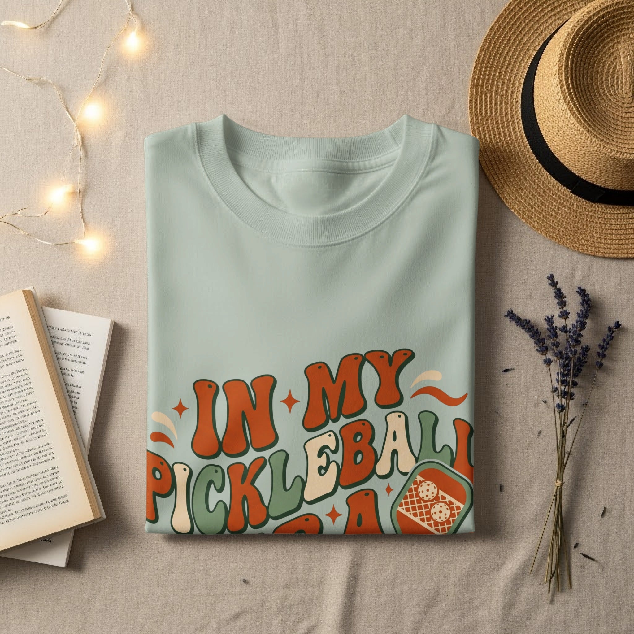 Mint green t-shirt with "In My Pickleball Era" graphic and pickleball paddle.