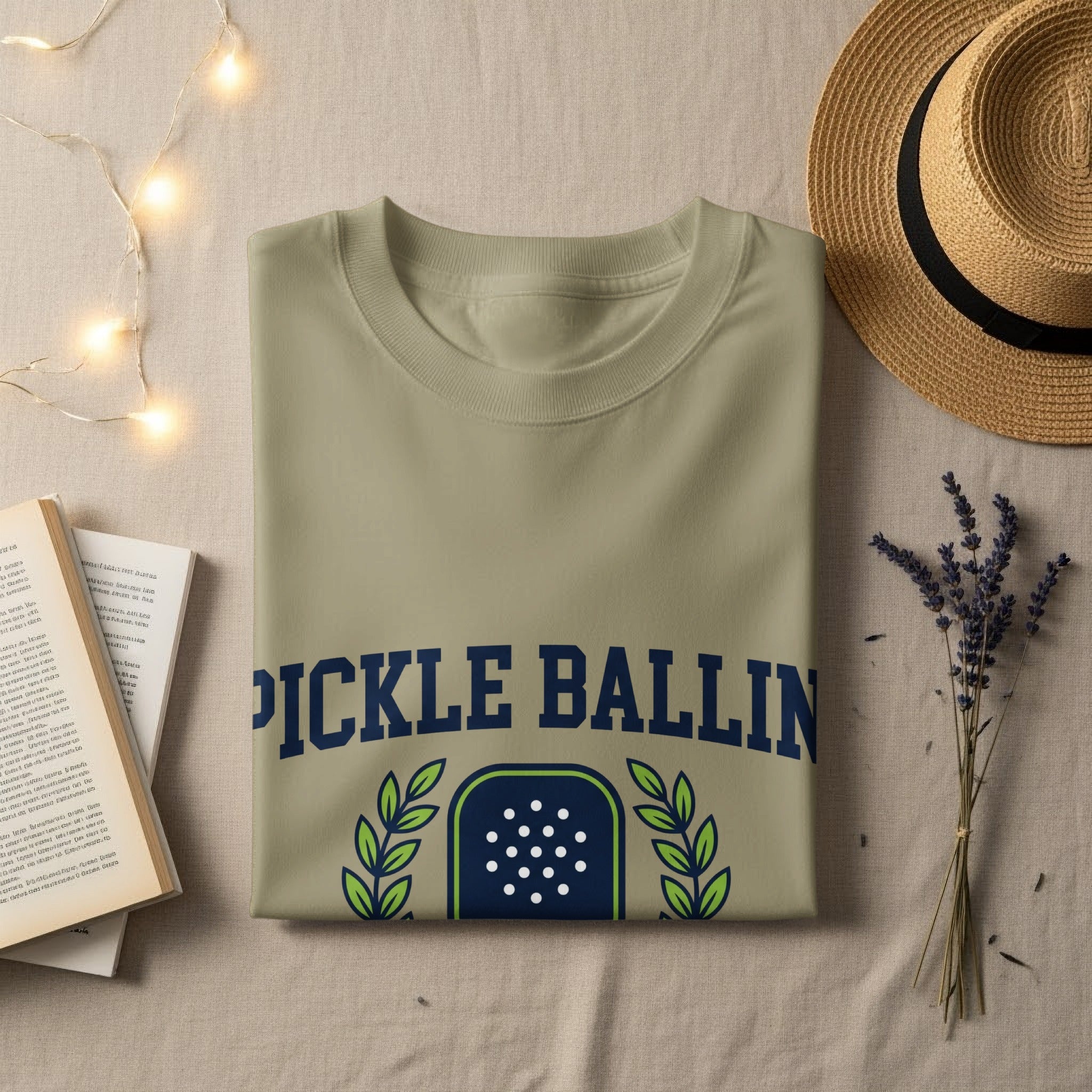 Olive green t-shirt with "PICKLE BALLIN" text and a shield graphic.