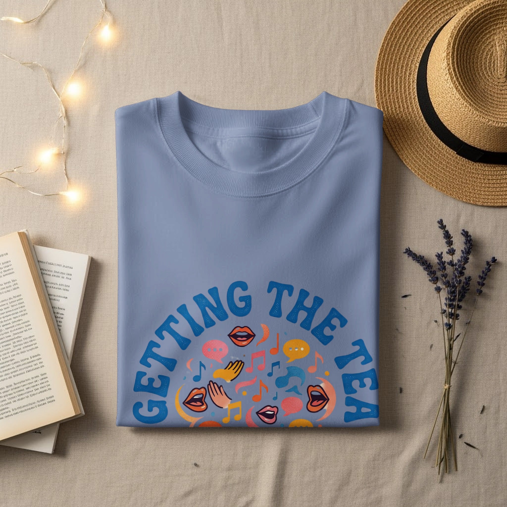 Blue t-shirt with "Getting the Tea" text and colorful speech bubbles.