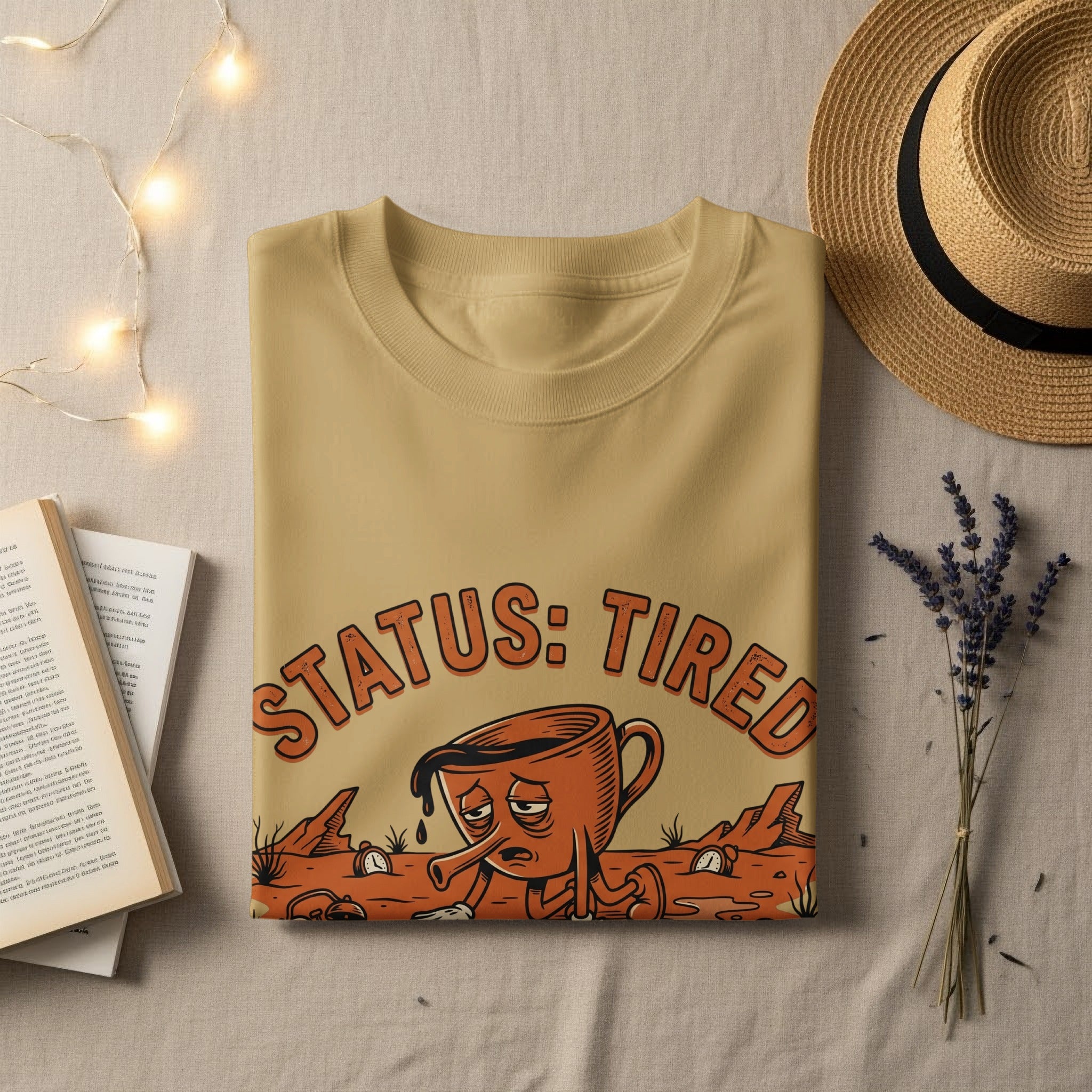 T-shirt with "STATUS: TIRED" text and a weary coffee cup graphic.