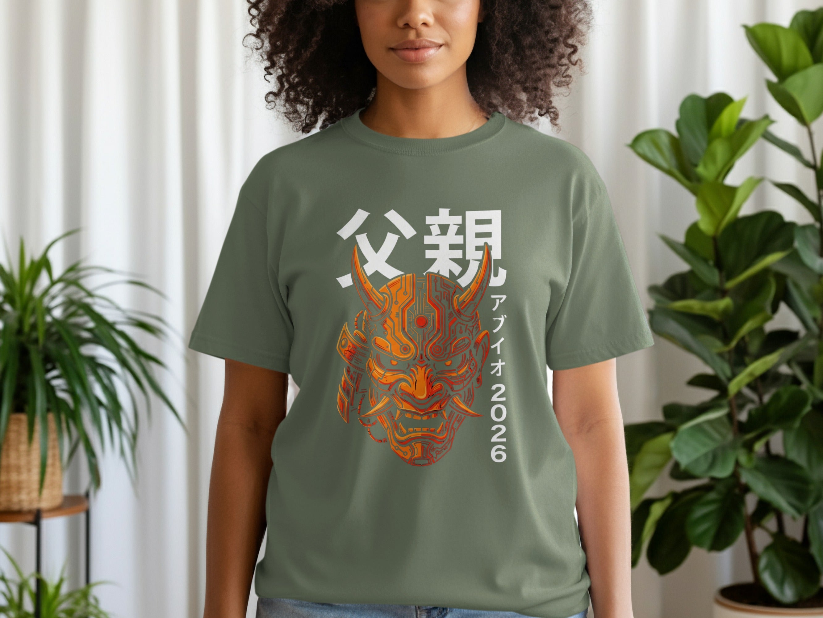 Green t-shirt with a vibrant orange and red oni mask and Japanese text.