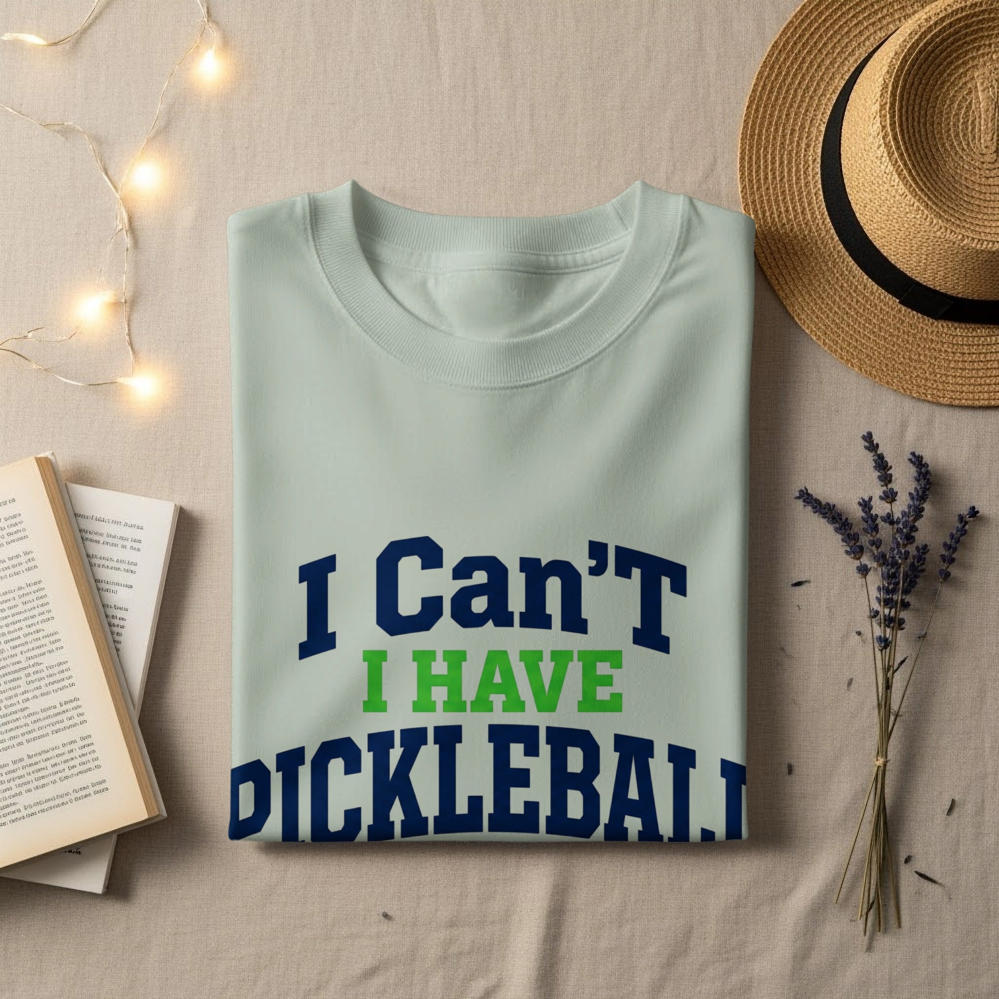 Light blue t-shirt with "I Can't I Have Pickleball" text.