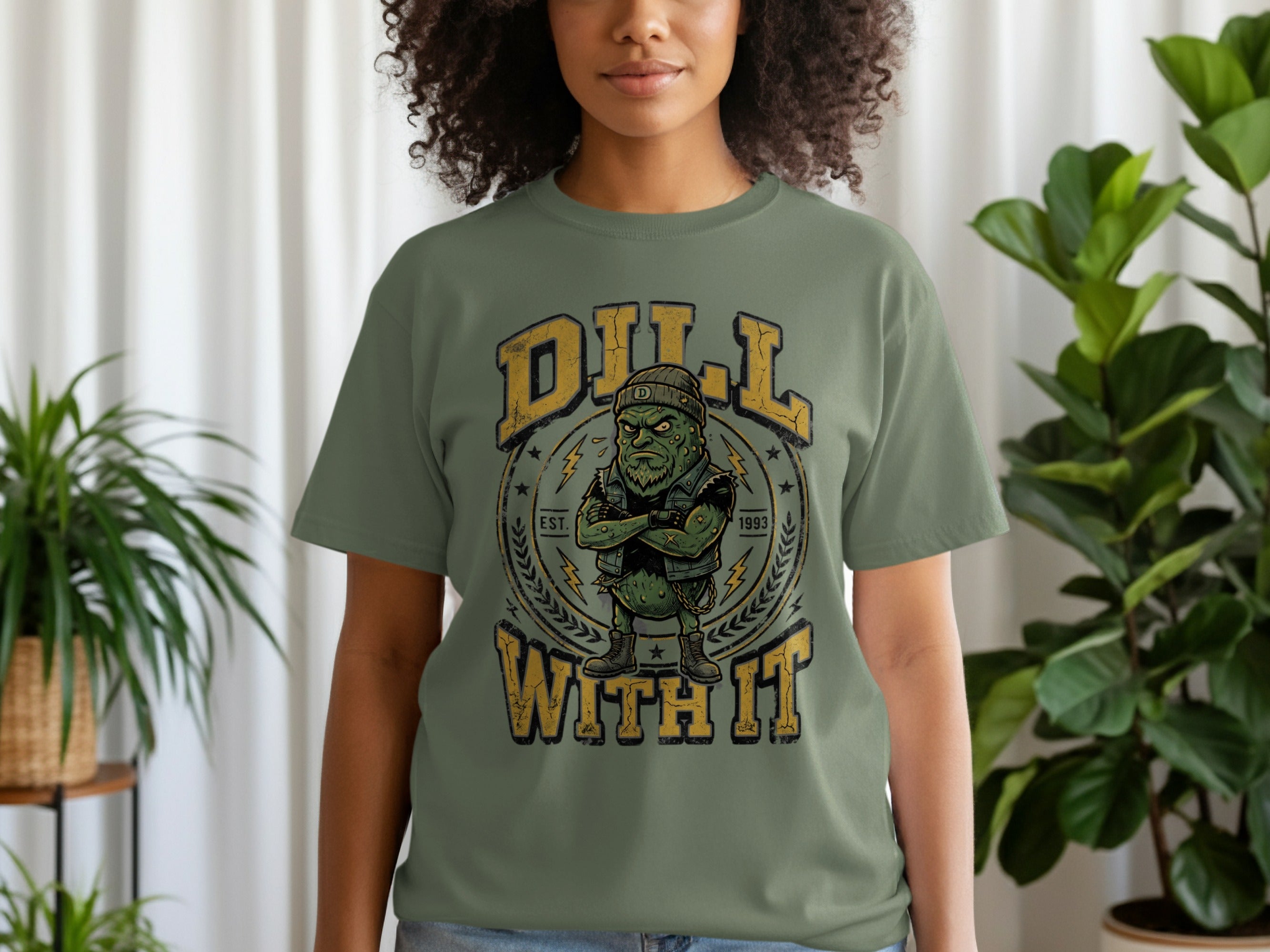 T-shirt with a cartoon pickle wearing a beanie and vest, "Dill With It" text.