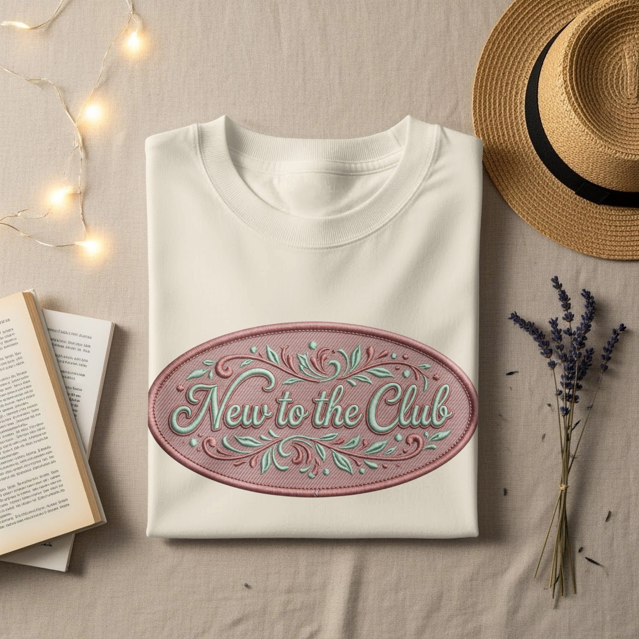 Cream t-shirt with "New to the Club" text inside an oval design.