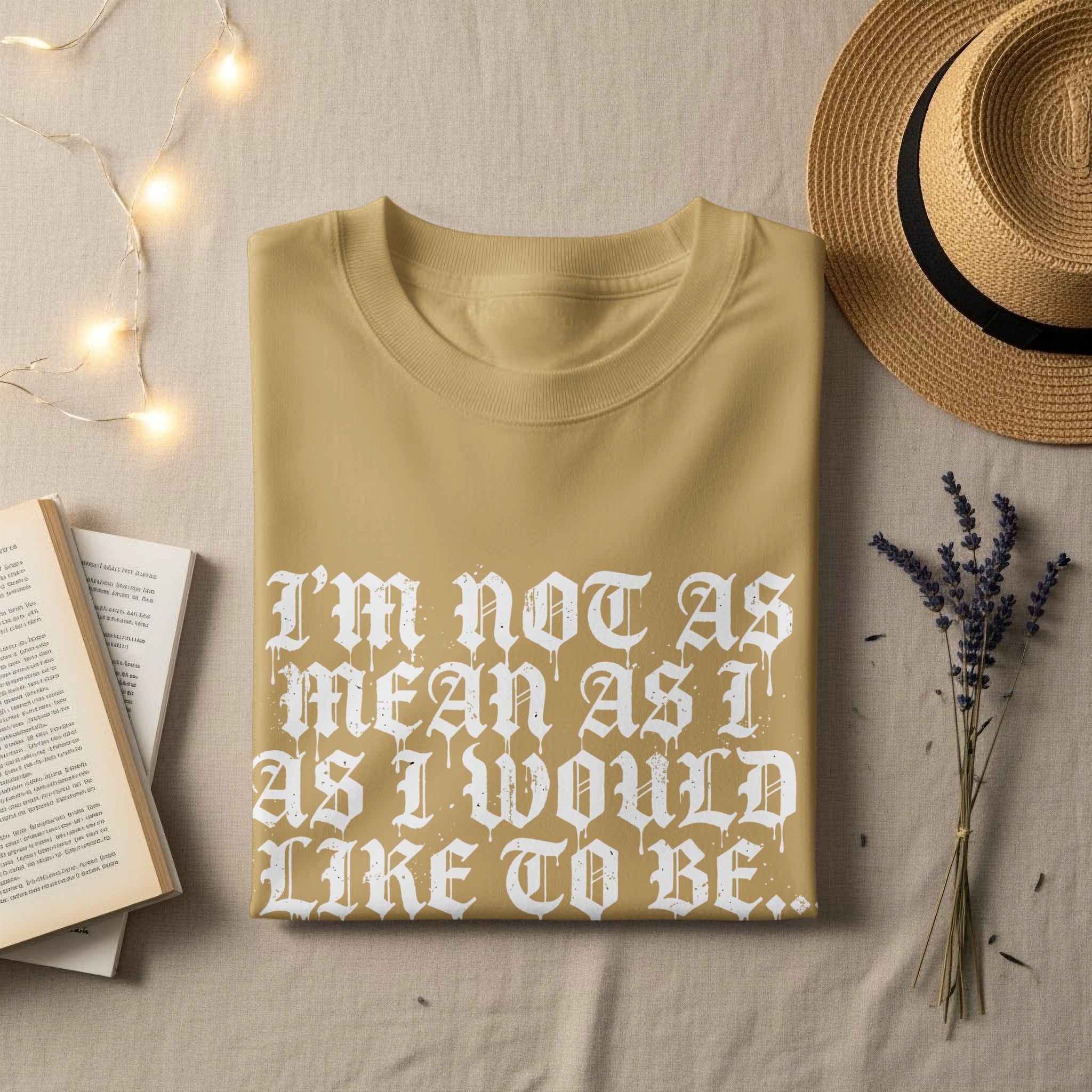 Tan t-shirt with white gothic lettering: "I'M NOT AS MEAN AS I WOULD LIKE TO BE."