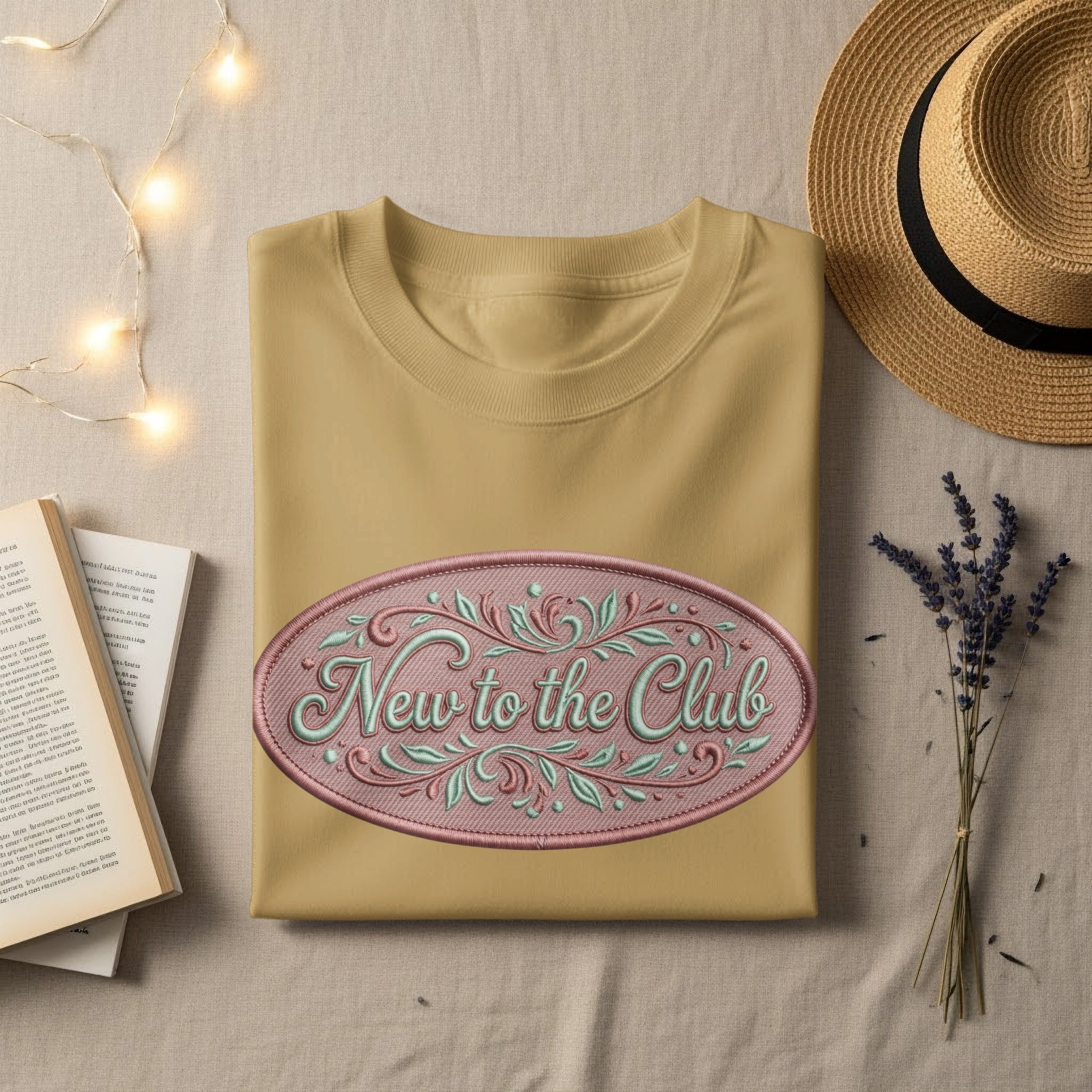 Yellow t-shirt with "New to the Club" text in an oval emblem.