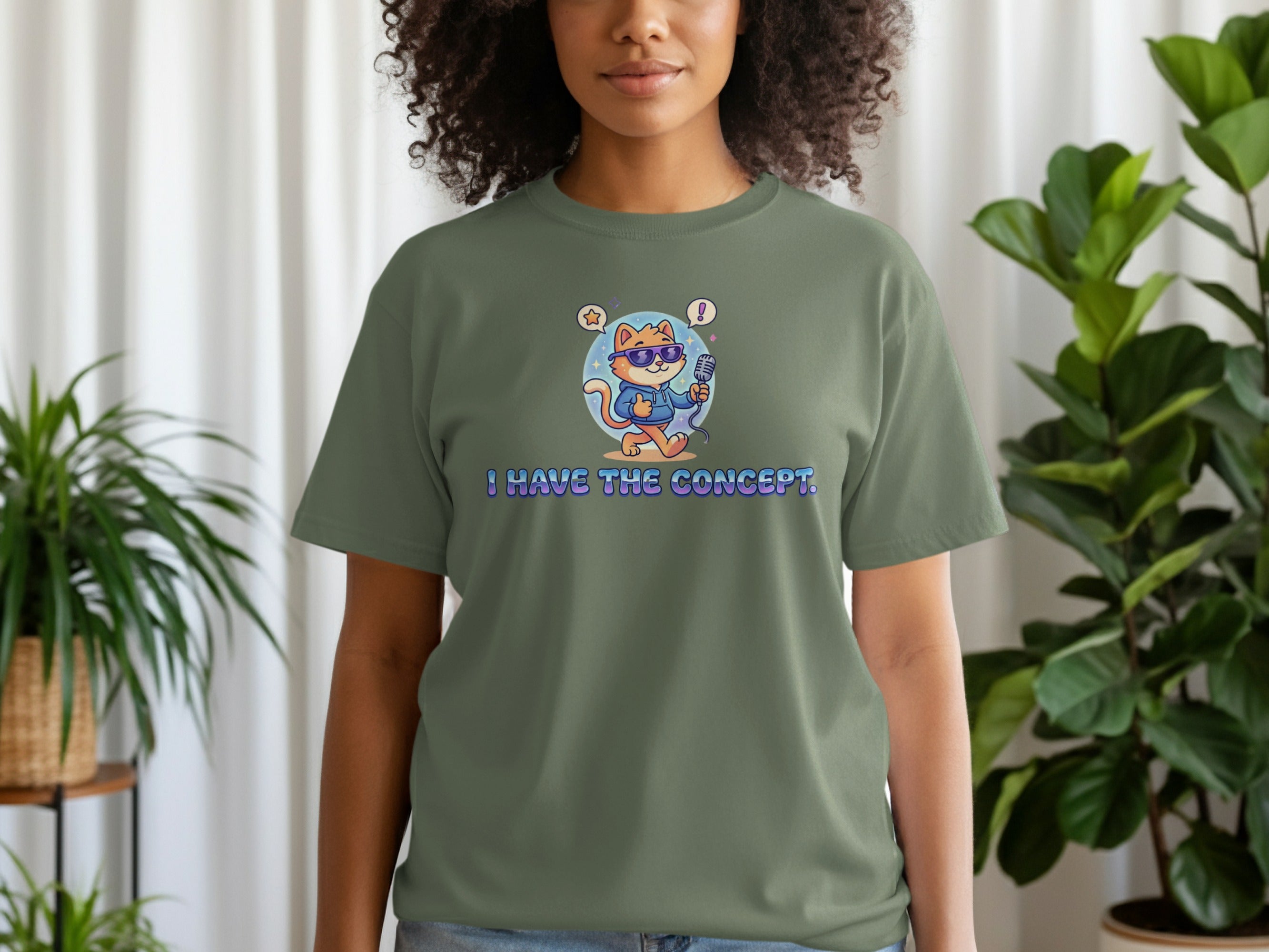 T-shirt with green background featuring a cartoon cat holding a microphone and wearing sunglasses.