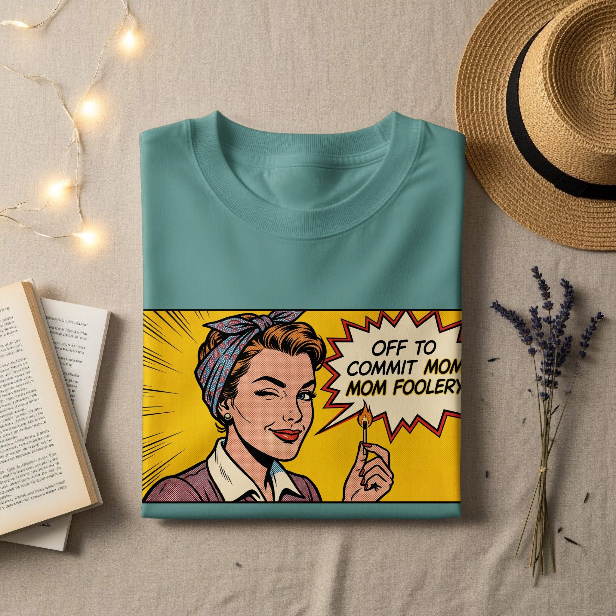 Teal t-shirt with comic-style graphic of a winking woman holding a match.