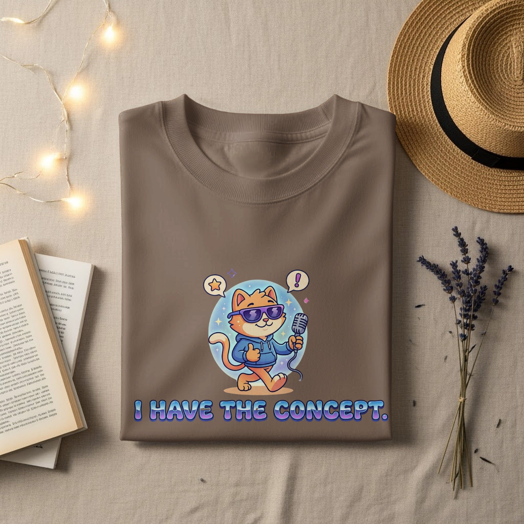Brown t-shirt with cartoon cat holding microphone, saying "I HAVE THE CONCEPT."