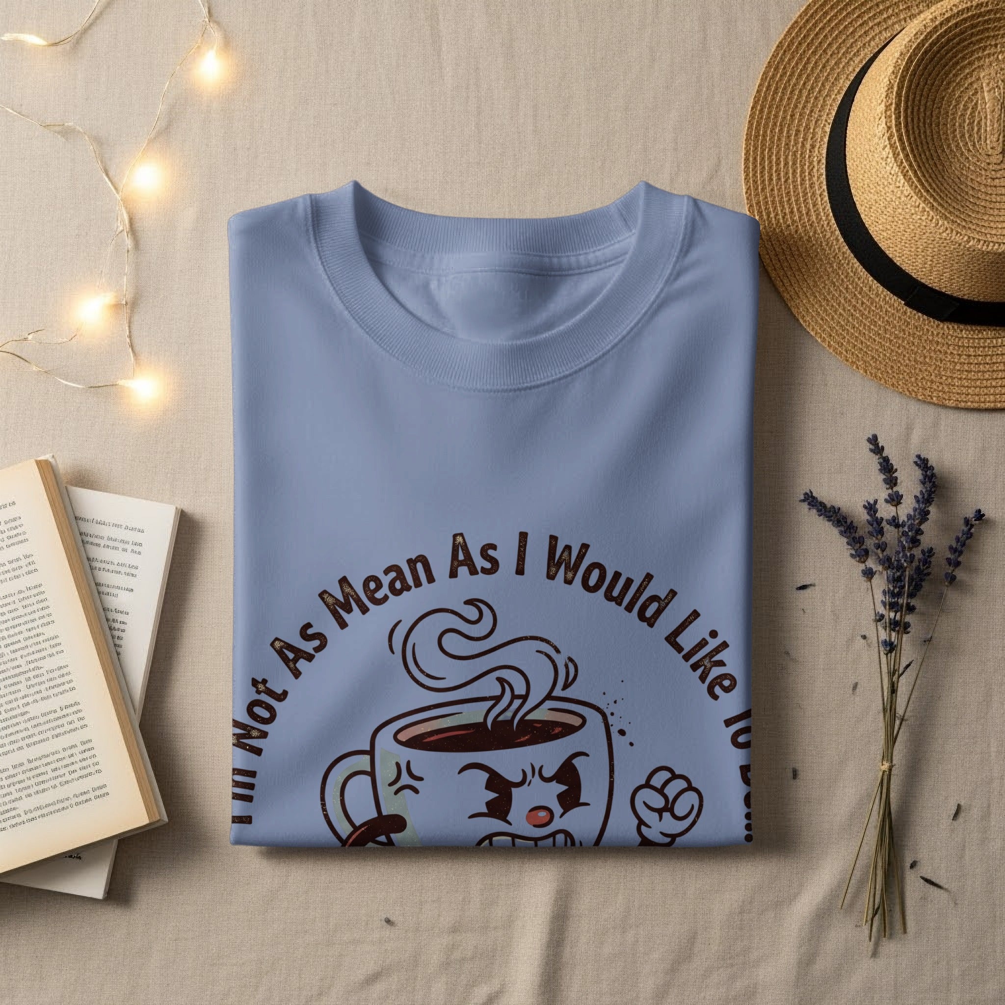 Light blue t-shirt with cartoon coffee cup graphic and text "Not As Mean As I Would Like To".