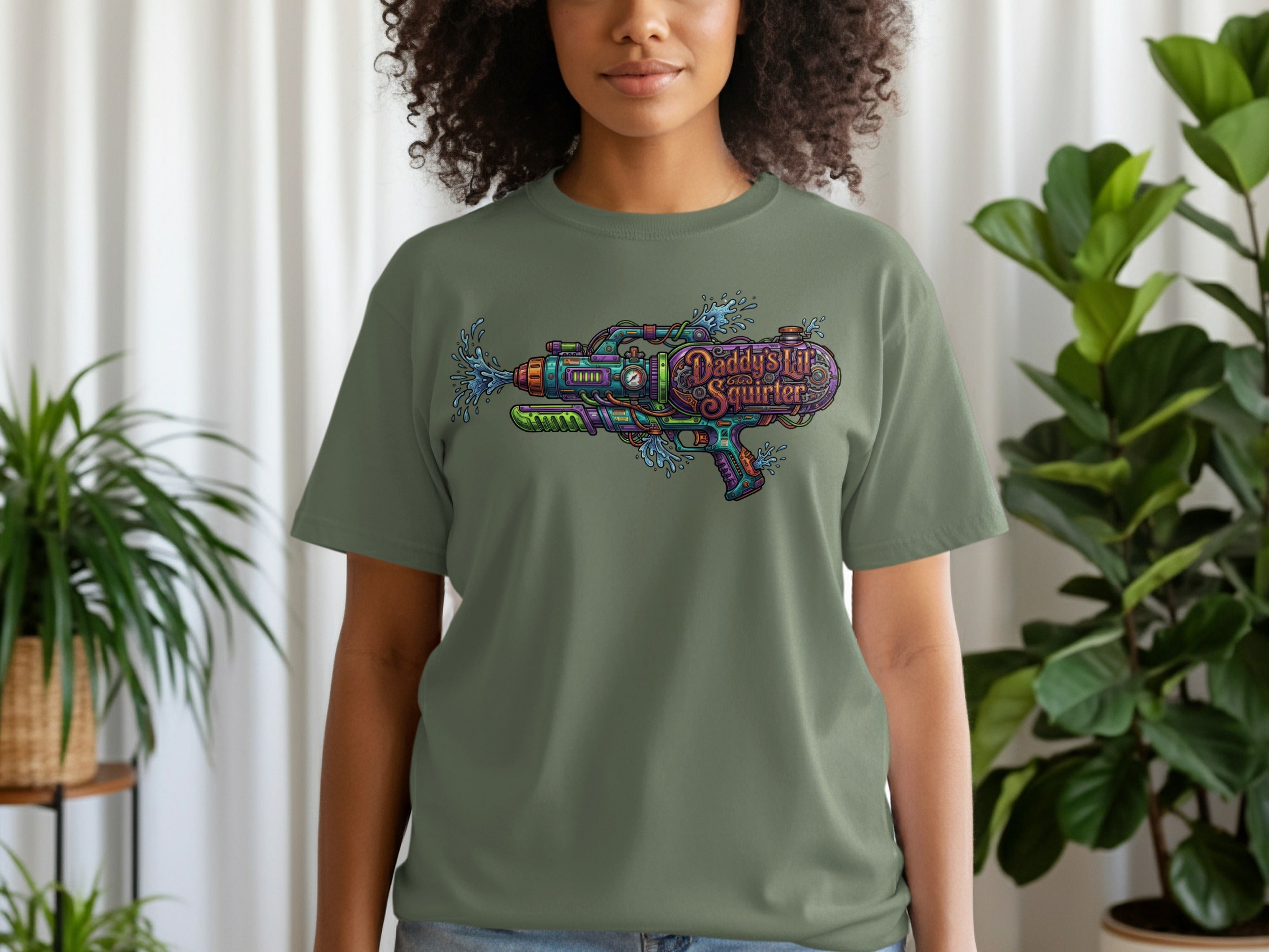 Green t-shirt with "Daddy's Little Squirt'r" text and a colorful water gun graphic.