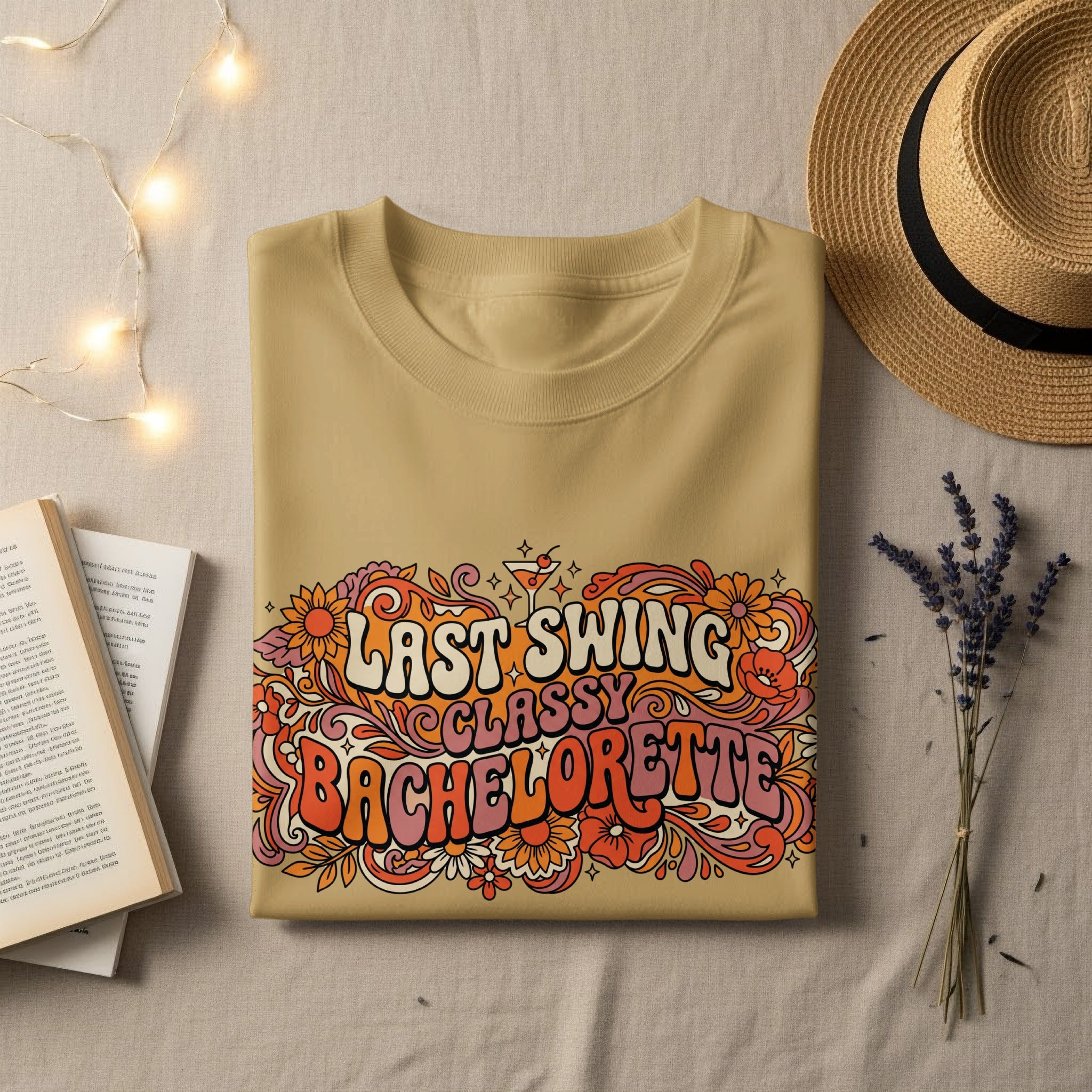 Tan t-shirt with "Last Swing Bachelorette" in retro floral font.