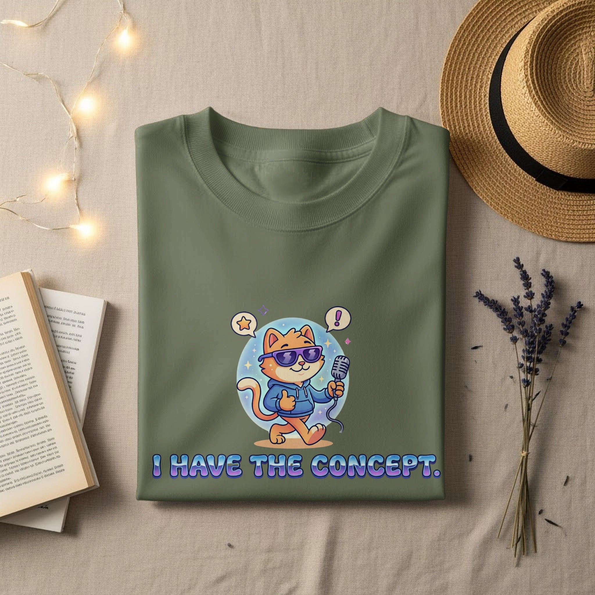 Green t-shirt with cartoon cat holding microphone, text "I HAVE THE CONCEPT."