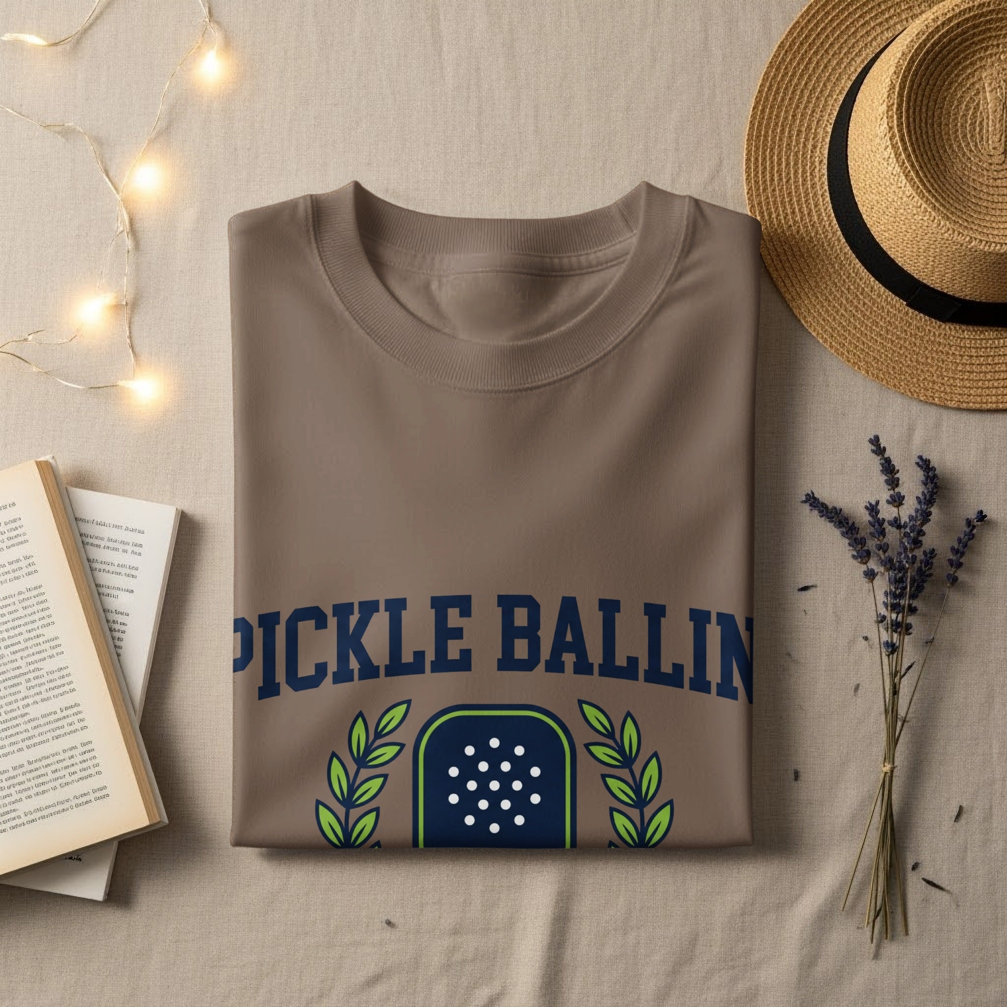 Brown t-shirt with "PICKLE BALLIN" text and laurel wreath emblem.