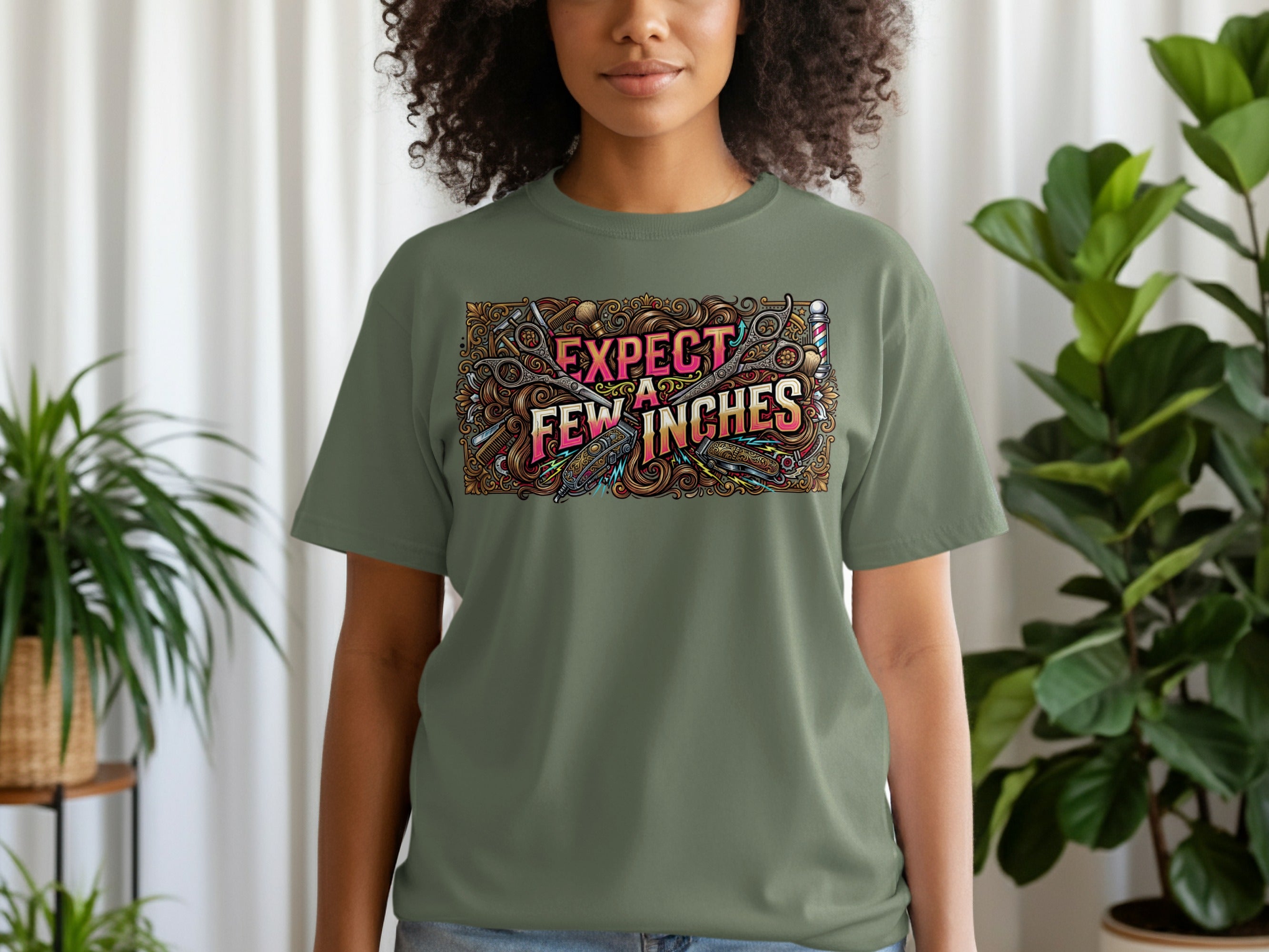 Green t-shirt with "Expect Few Inches" text and scissors illustration.