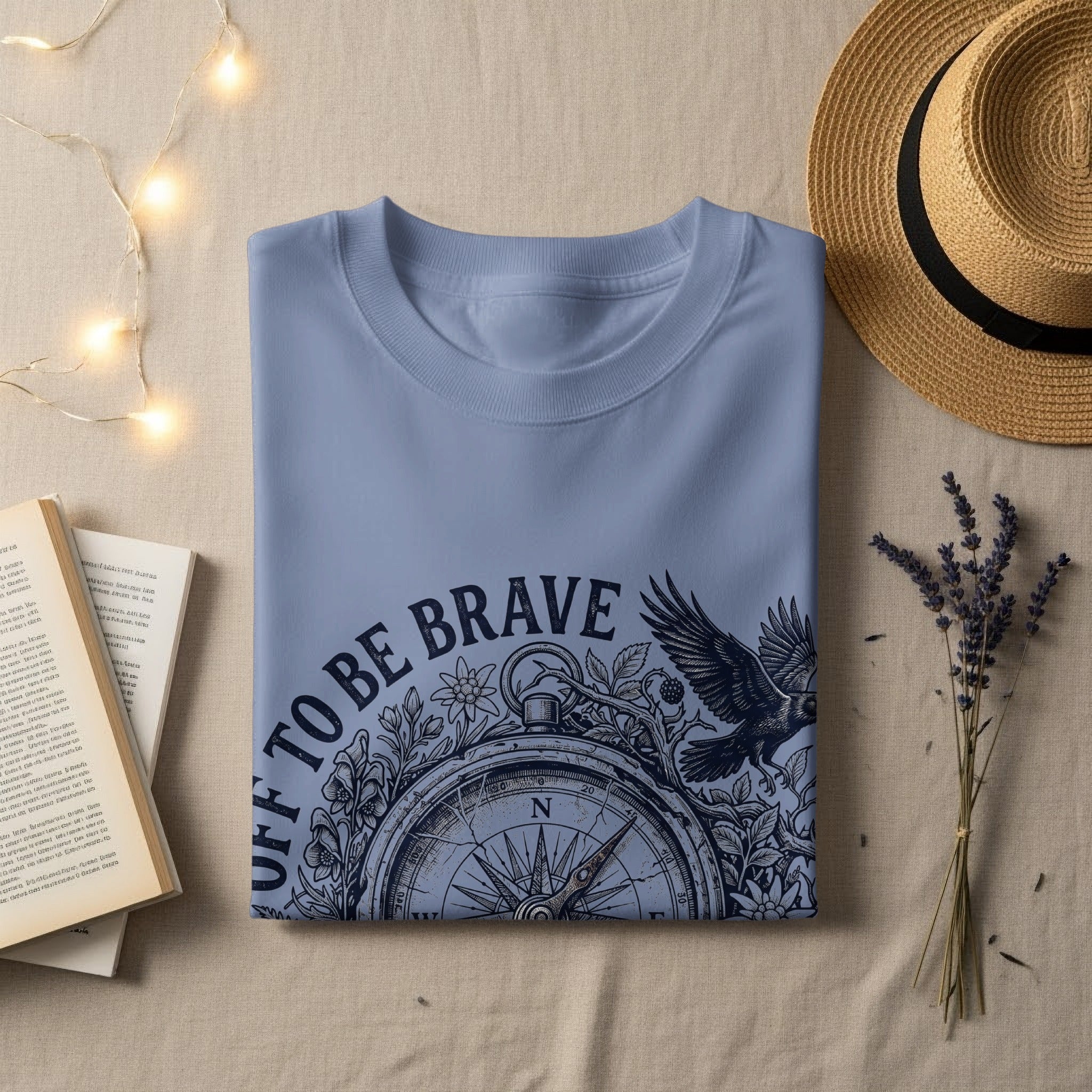 Light blue t-shirt with "TO BE BRAVE" and compass design.