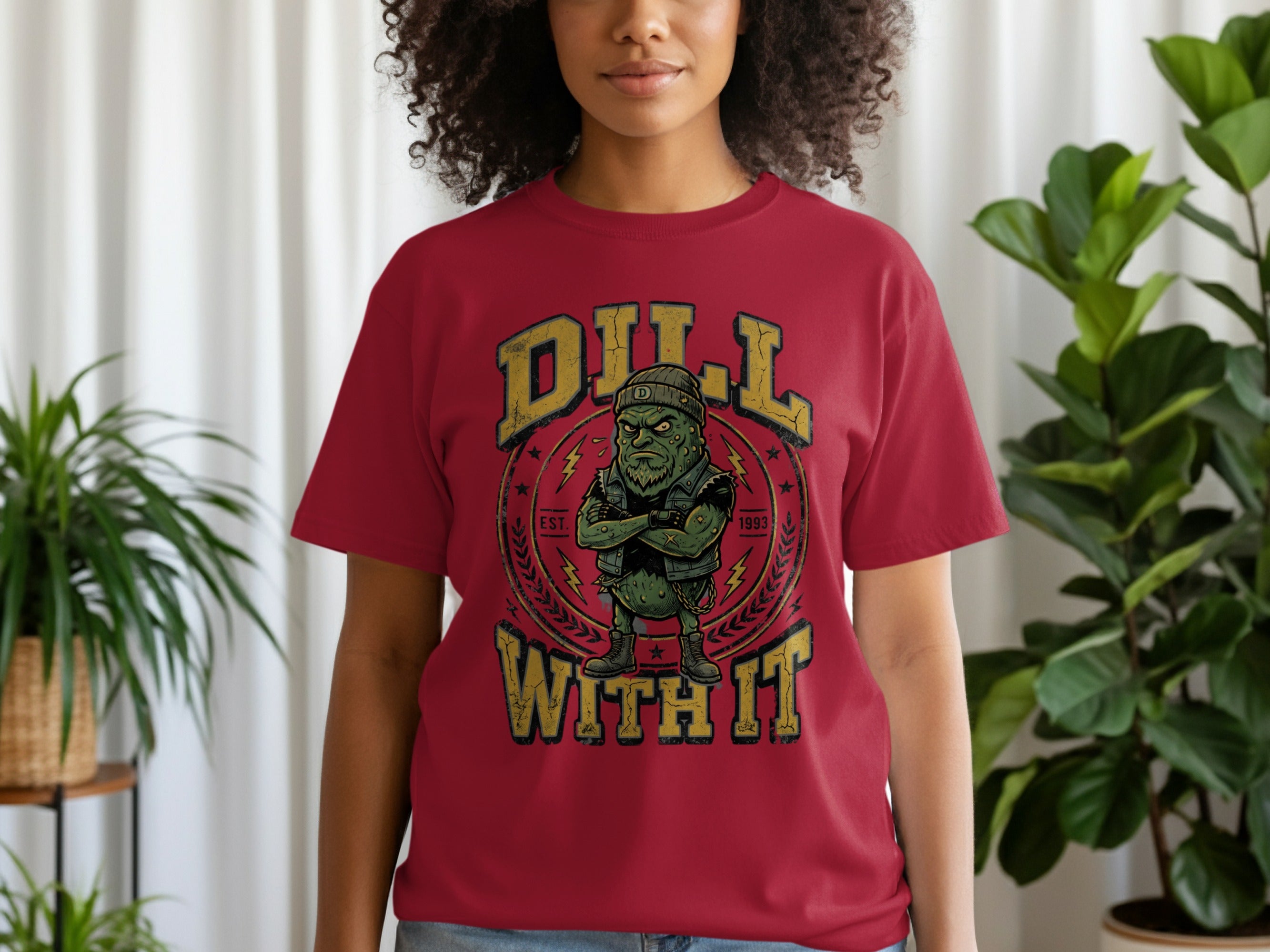 Maroon t-shirt with graphic of a grumpy pickle wearing a beanie and vest, with text "DILL WITH IT 1993".