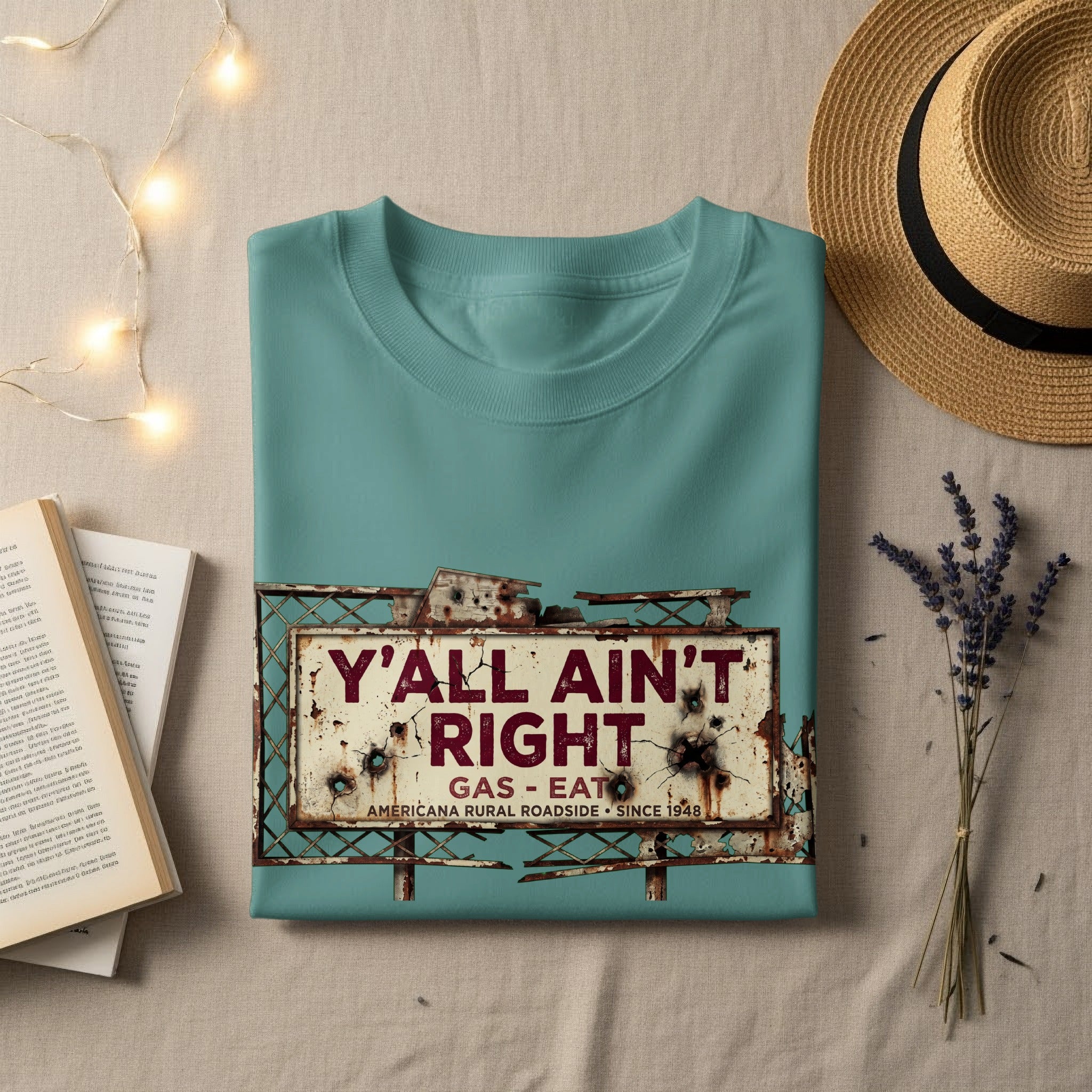 Teal t-shirt with "Y'all Ain't Right Gas - Eat" rustic roadside sign graphic.