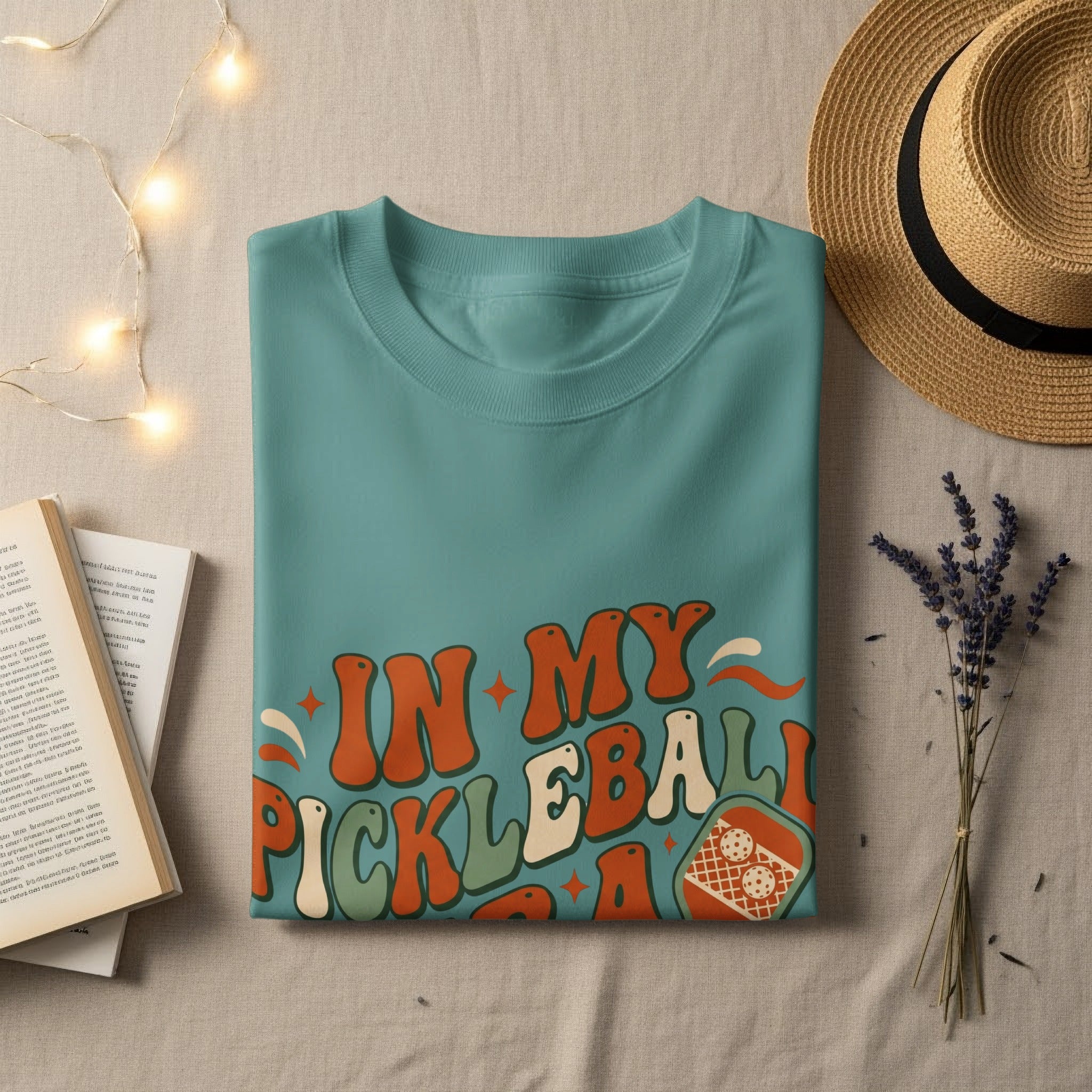 Teal t-shirt with "In My Pickleball Era" text and pickleball graphic.