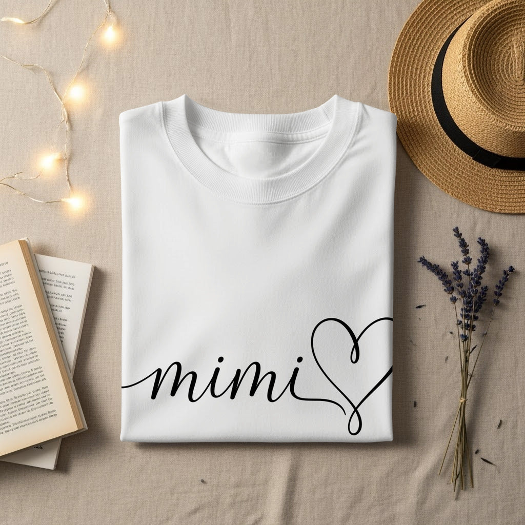 White t-shirt with "mimi" and a heart design.