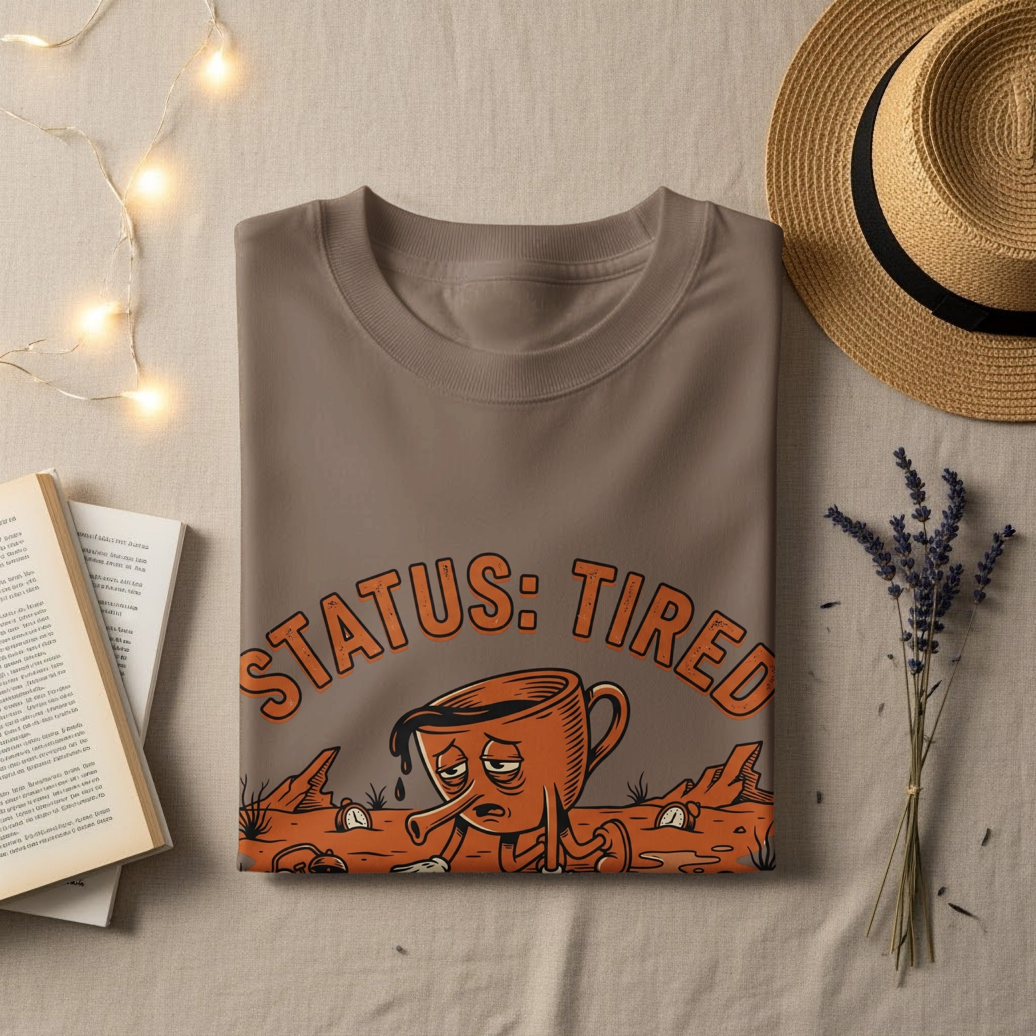 Brown t-shirt with "STATUS: TIRED" text and a cartoon coffee cup character.