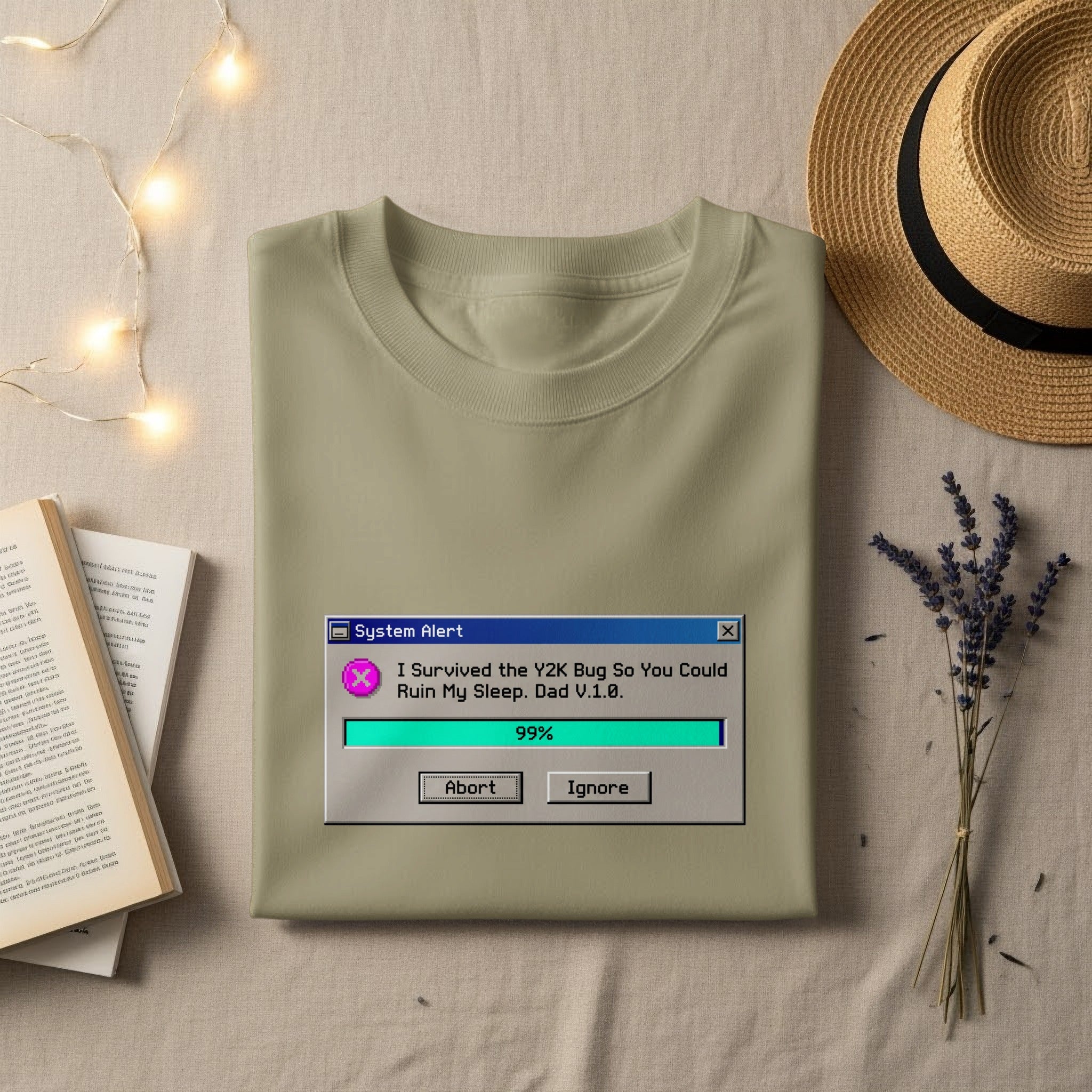 Light olive t-shirt with "System Alert" Y2K bug humor graphic.