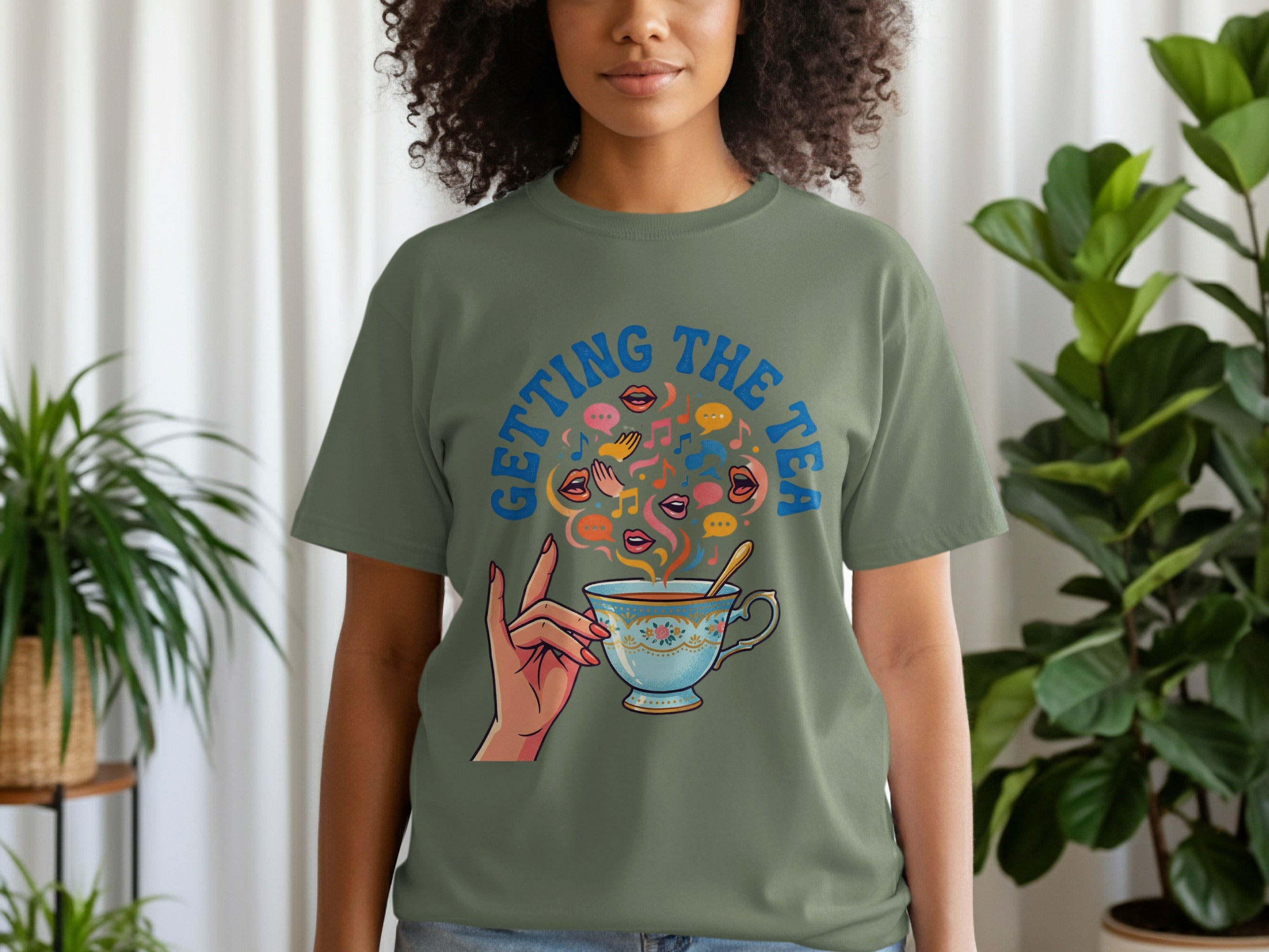 Woman wearing a green t-shirt with a teacup and "Getting the Tea" graphic.