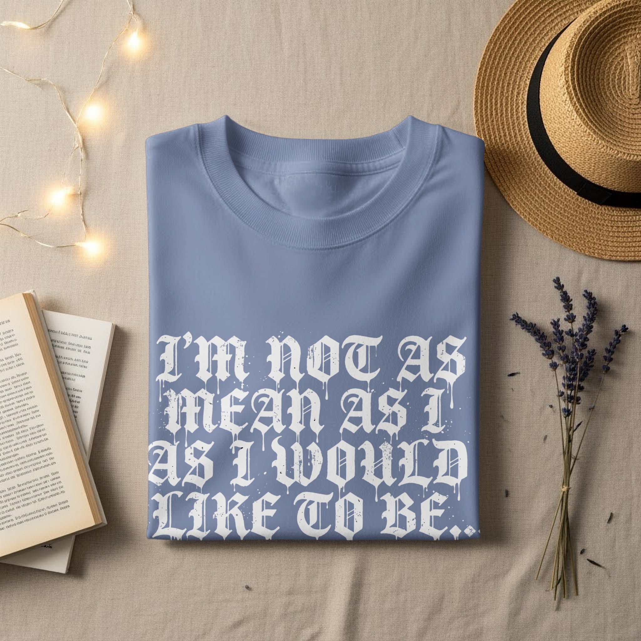 Light blue t-shirt with "I'M NOT AS MEAN AS I WOULD LIKE TO BE.." graphic.