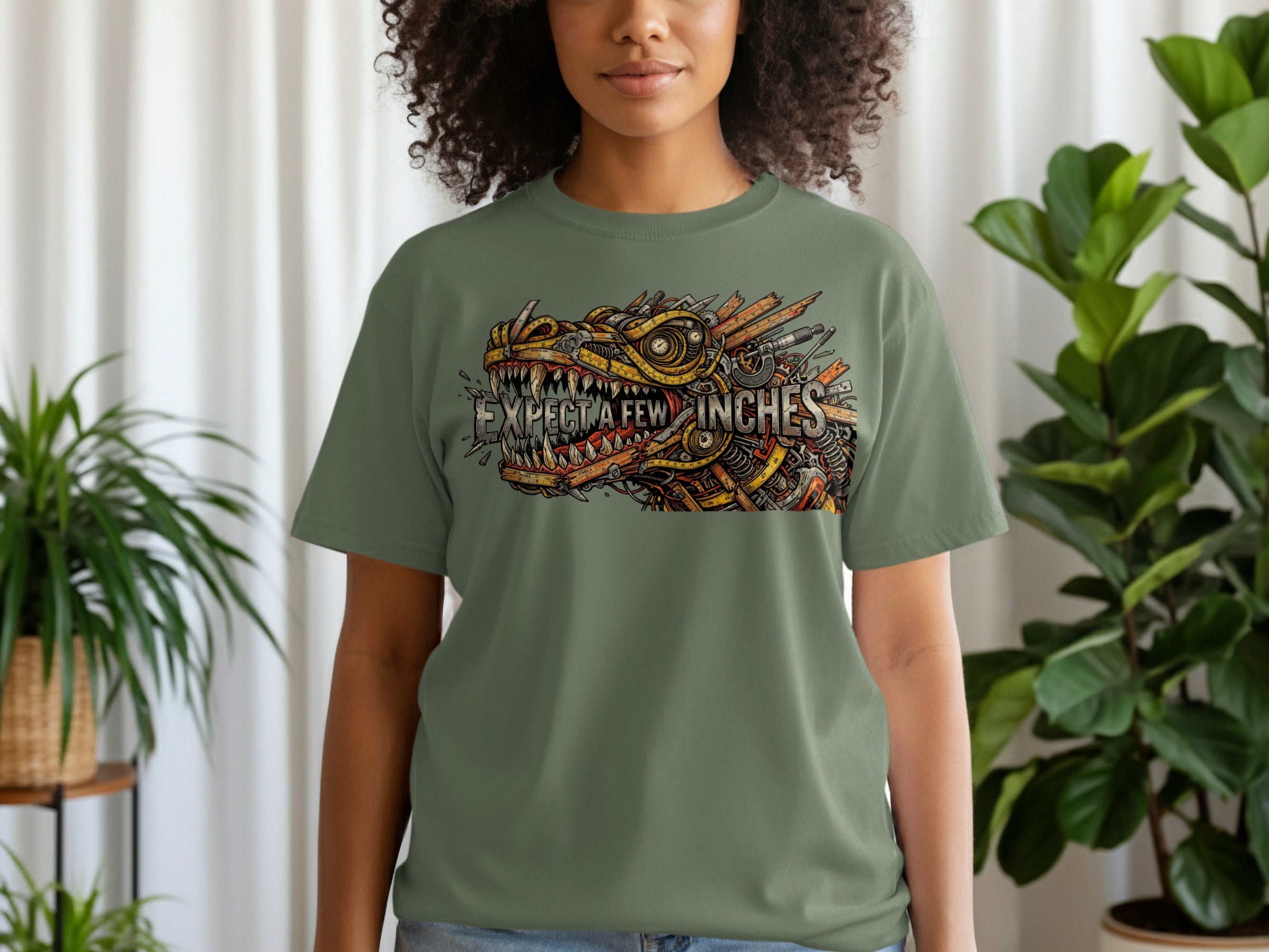 Green t-shirt with a mechanical dragon graphic and text "I EXPECT A FEW INCHES".