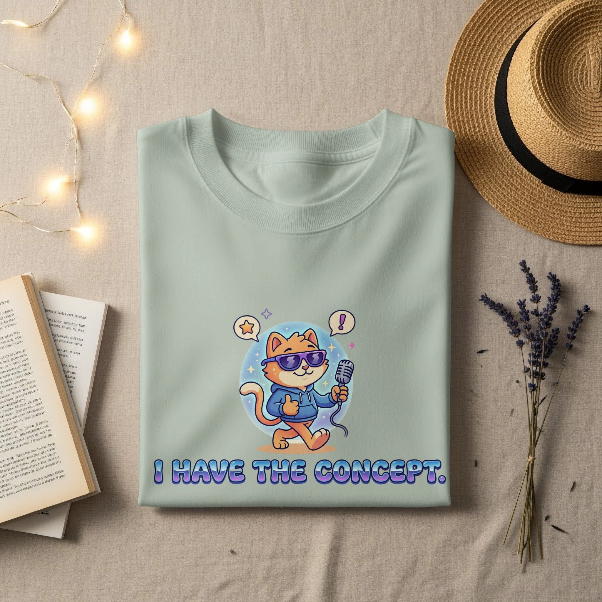 Light mint green t-shirt with cartoon cat holding microphone, saying "I HAVE THE CONCEPT."