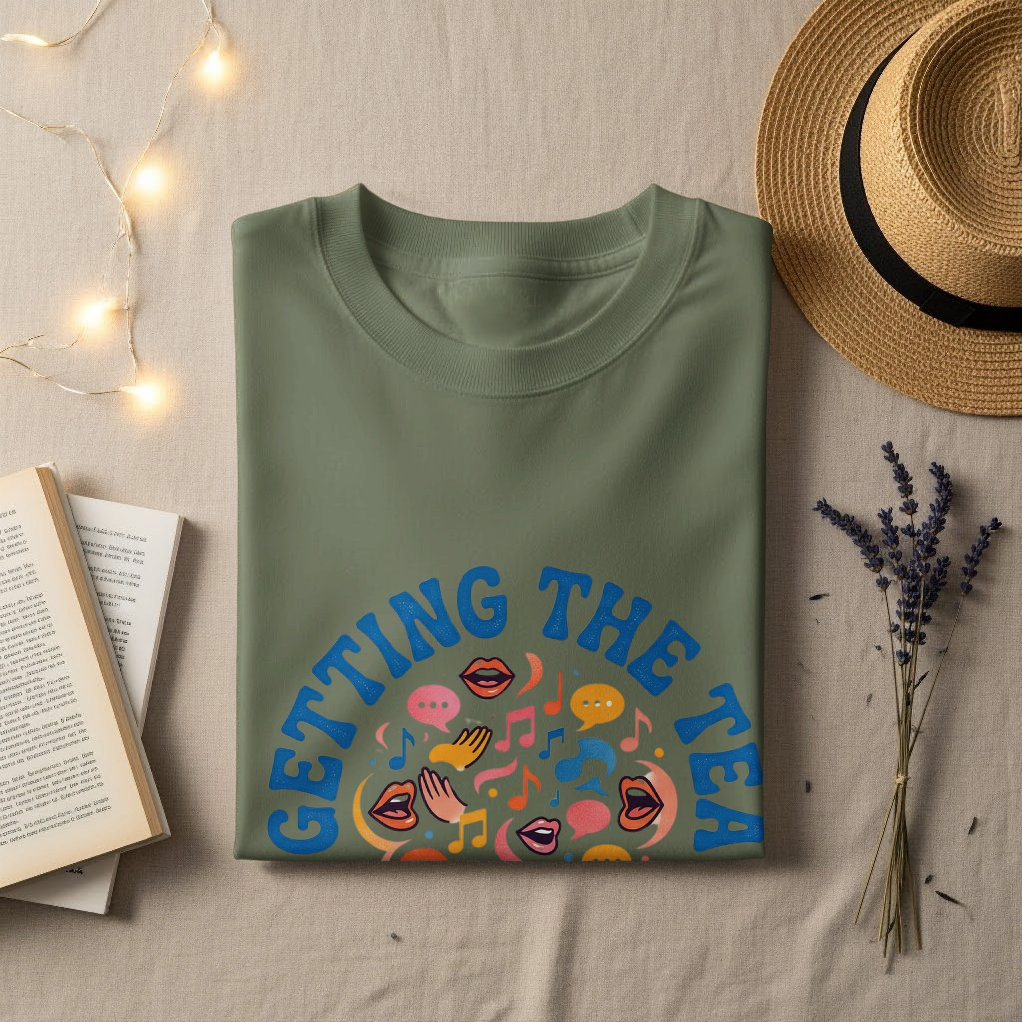 Olive green t-shirt with "GETTING THE TA" text and colorful speech and music graphics.