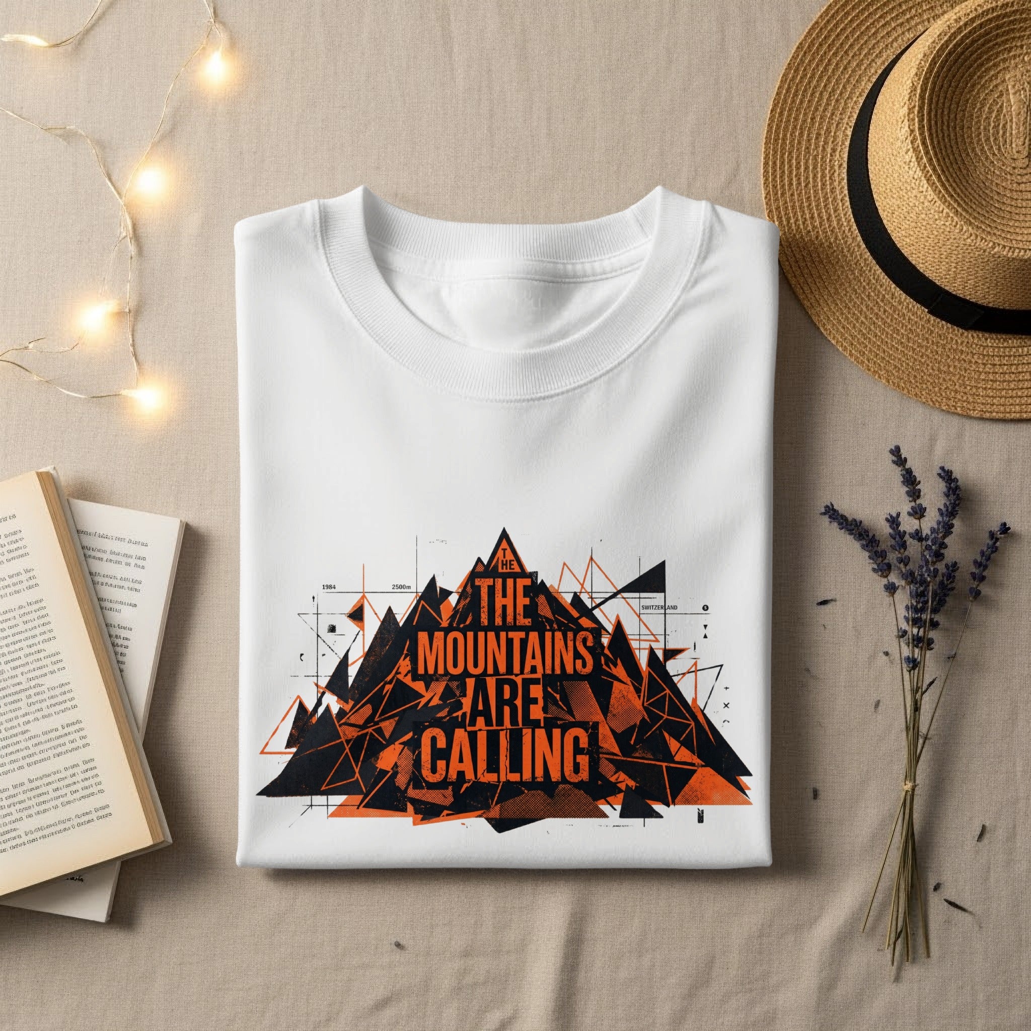 White t-shirt with orange mountain graphic and "The Mountains Are Calling" text.