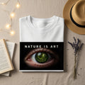 White t-shirt with "NATURE IS ART" text and a surreal eye graphic.