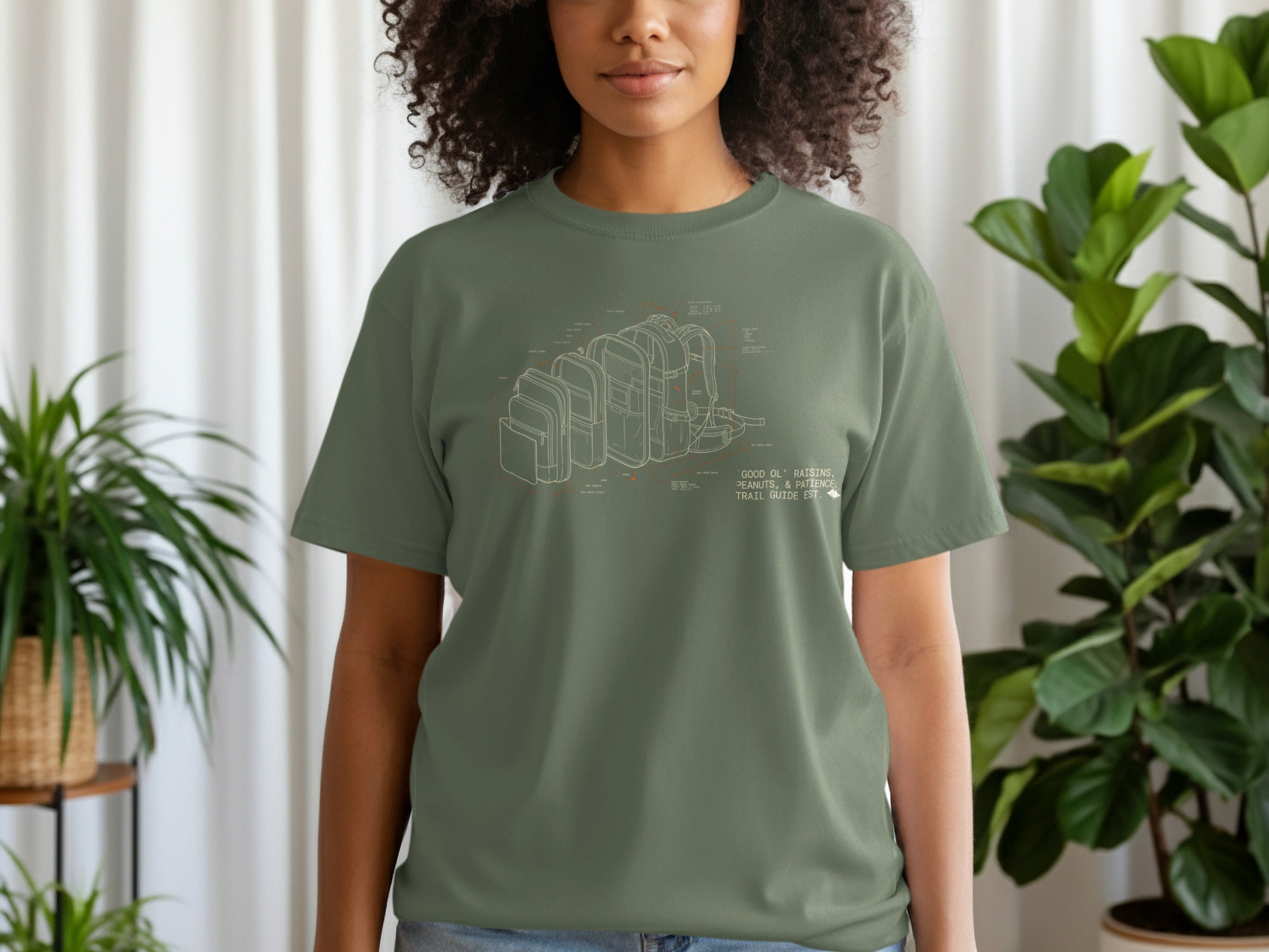 Green t-shirt with schematic diagram of backpacks and outdoor gear.